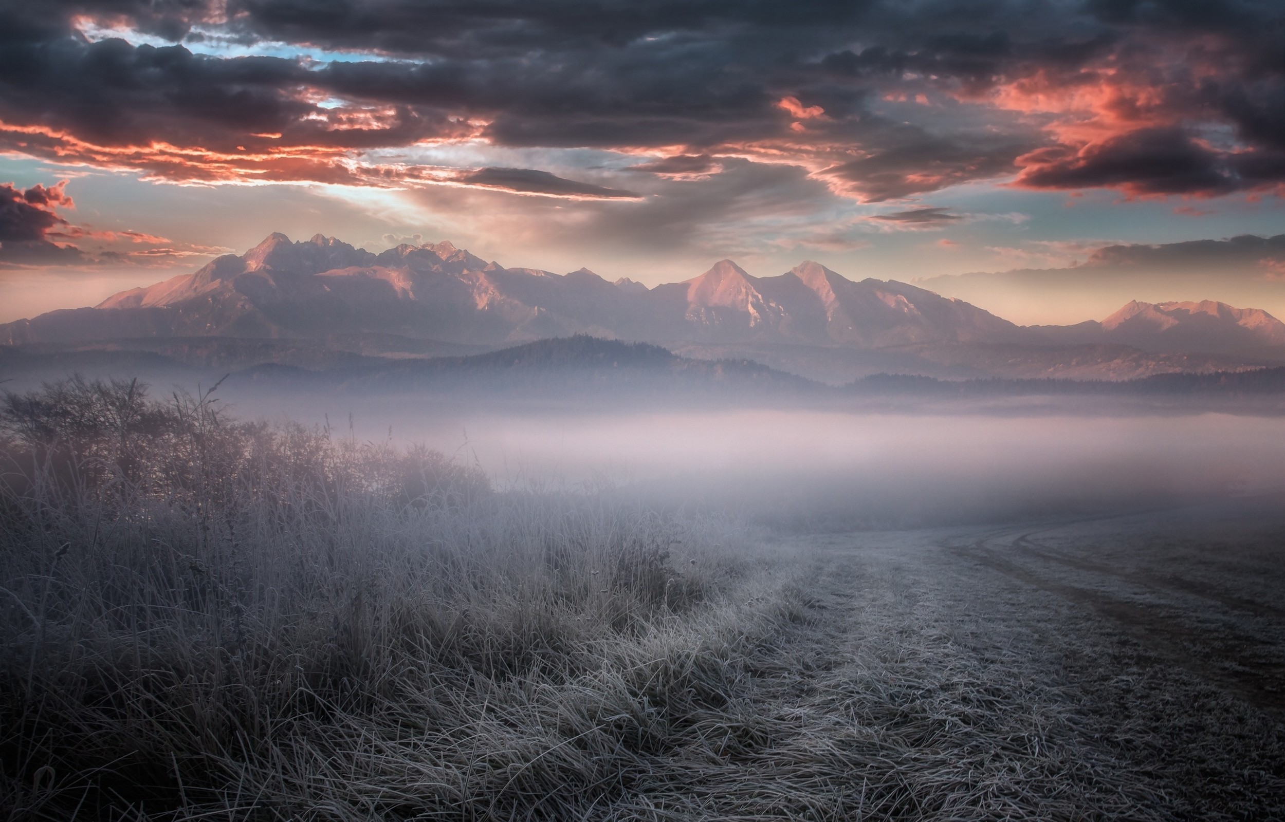 Misty Mountains Landscape with Frosty Grass and Dramatic Clouds HD Wallpaper