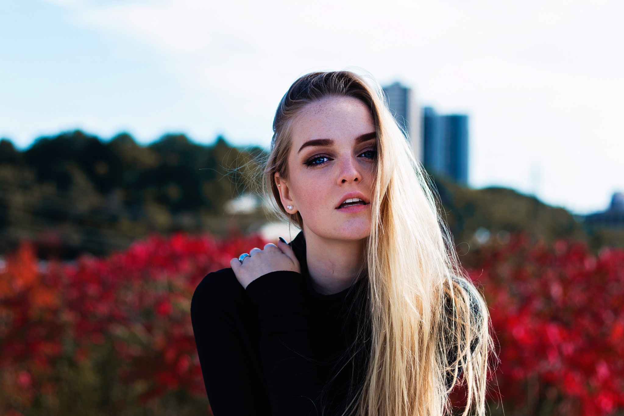 Woman with blonde hair and blue eyes outdoors HD Wallpaper