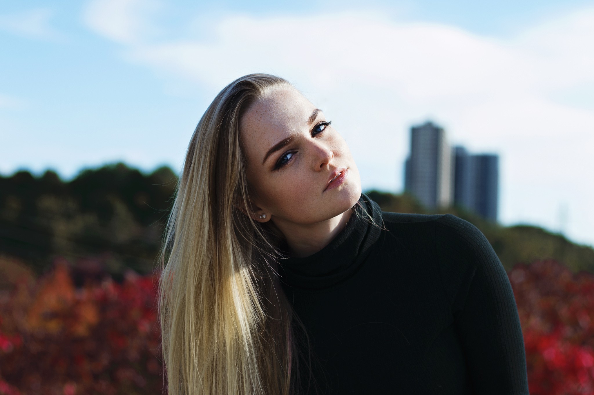 Woman with blonde hair wearing a black turtleneck HD Wallpaper