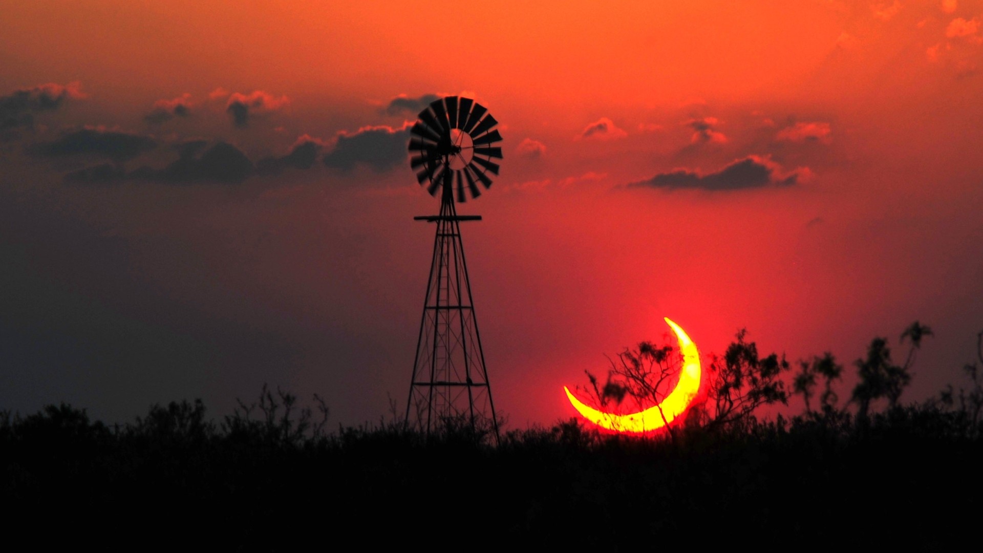 Texas sunset with windmill and solar eclipse HD Wallpaper