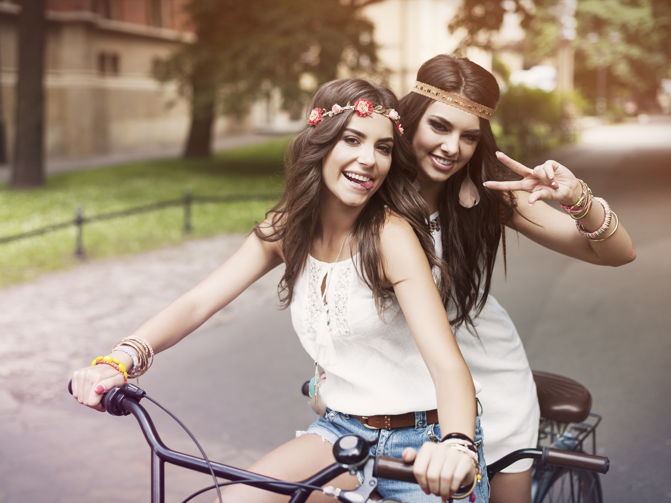 Two young women on a bicycle HD Wallpaper