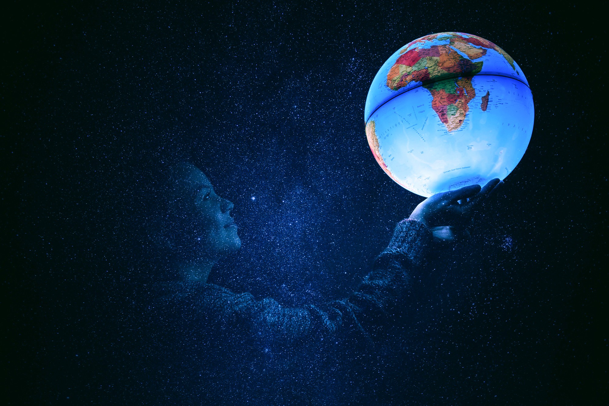 Woman holding a glowing globe in a starry night HD Wallpaper