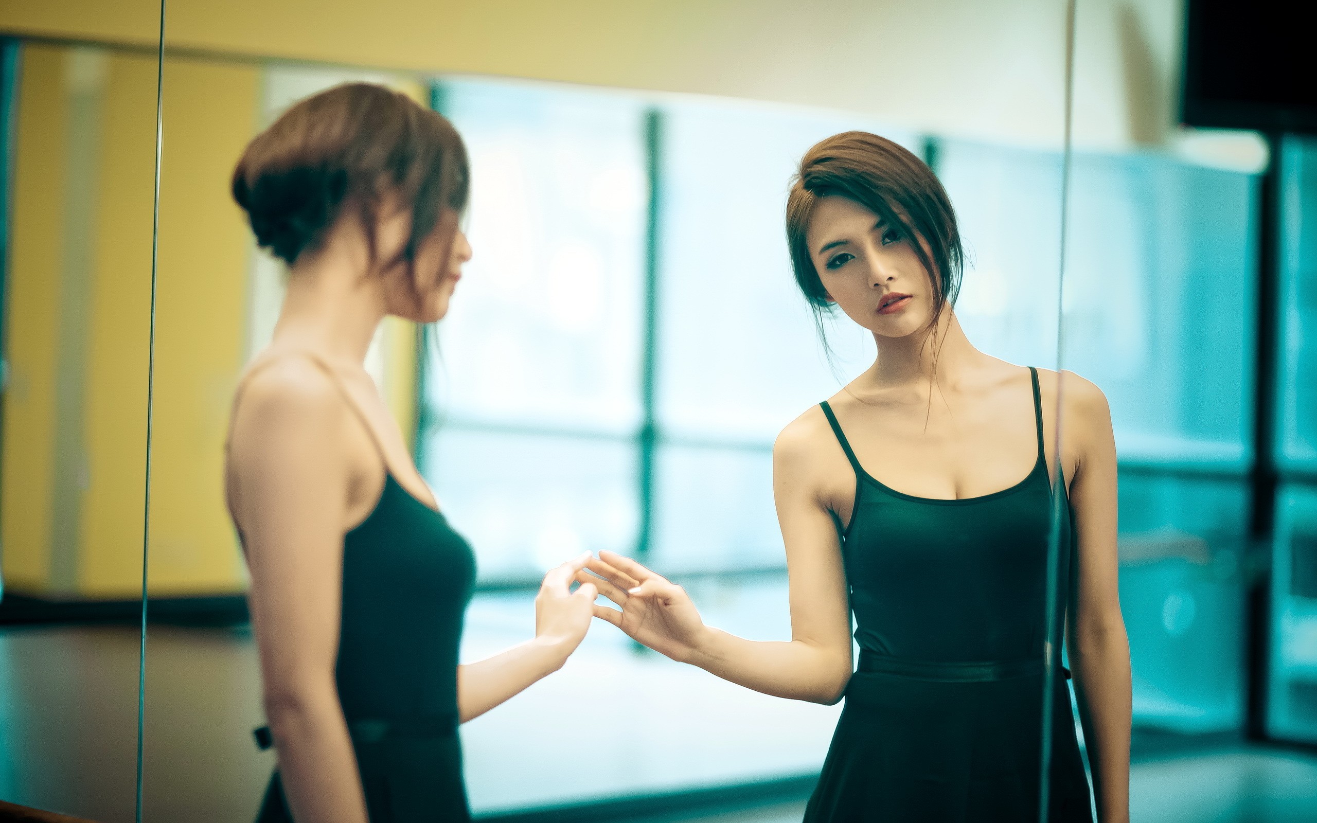 Asian woman in black dress looking in mirror HD Wallpaper