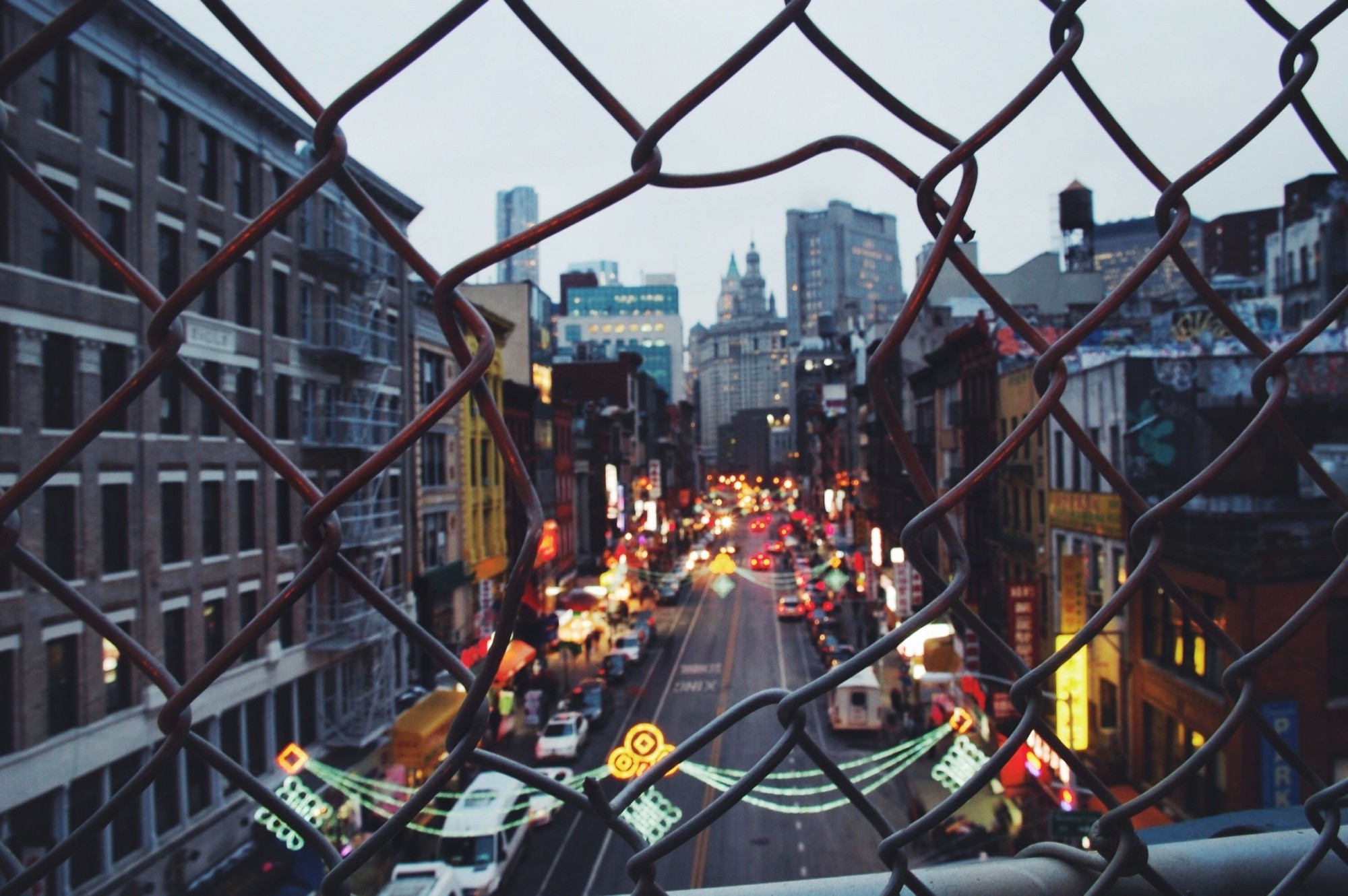 New York City street viewed through a chain-link fence HD Wallpaper