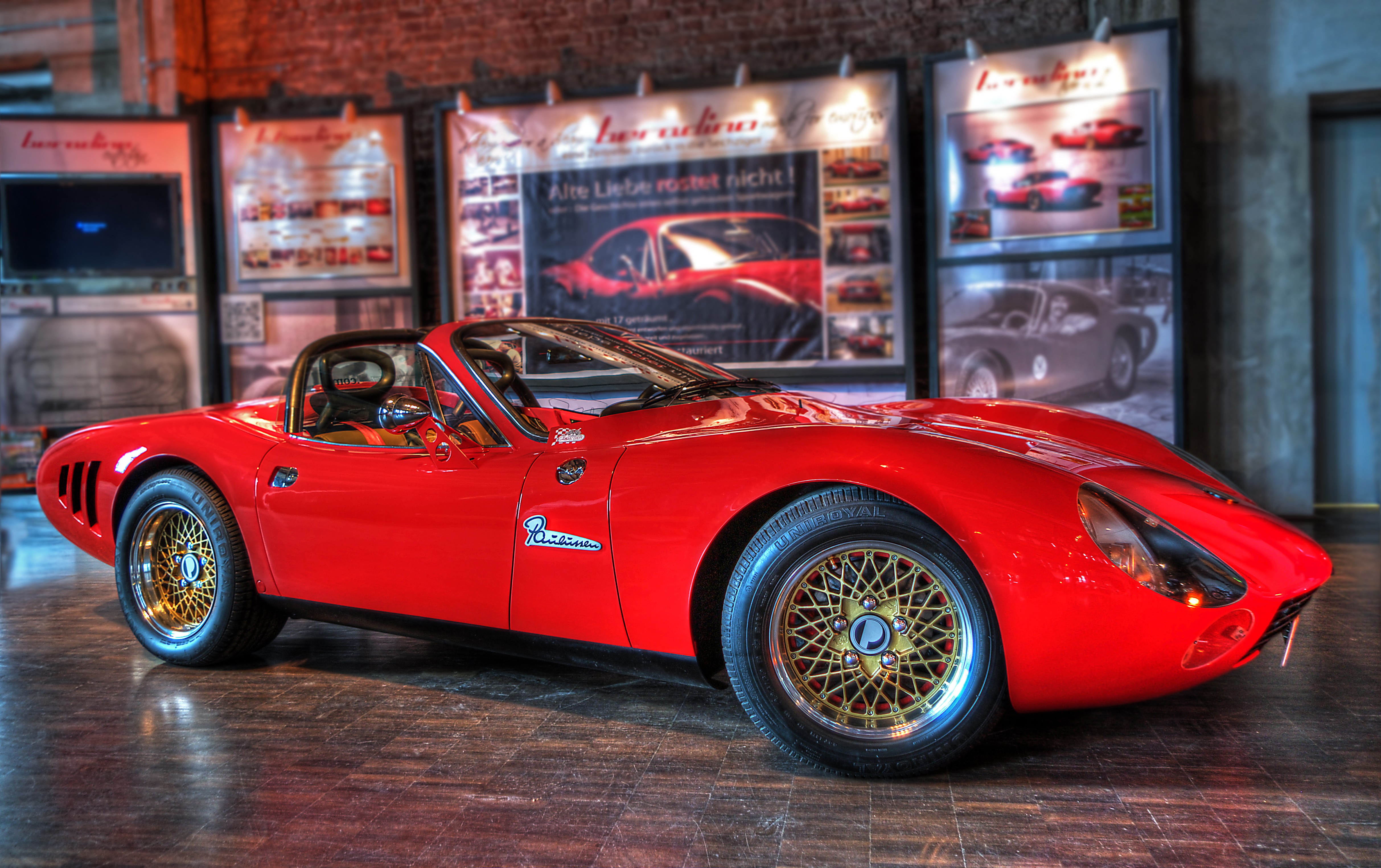 Red Beradino sports car on display HD Wallpaper