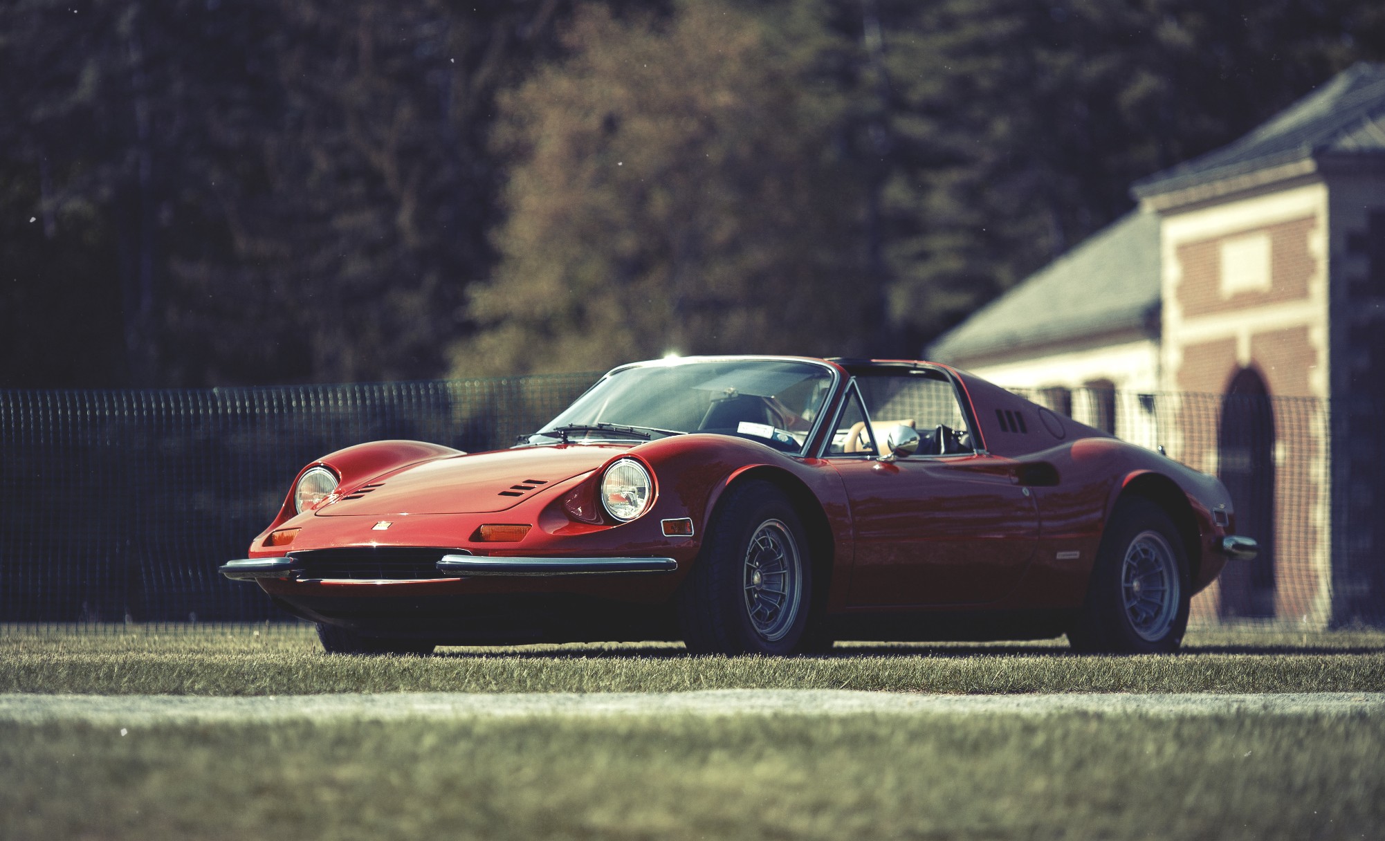 Red Ferrari Dino sports car on grass HD Wallpaper