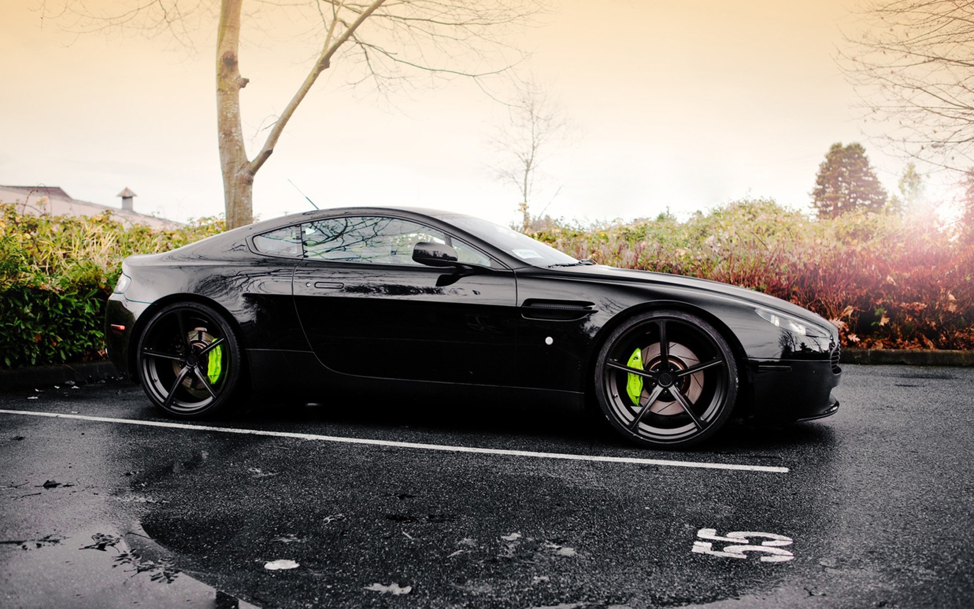 Black Aston Martin Vantage parked on wet asphalt HD Wallpaper