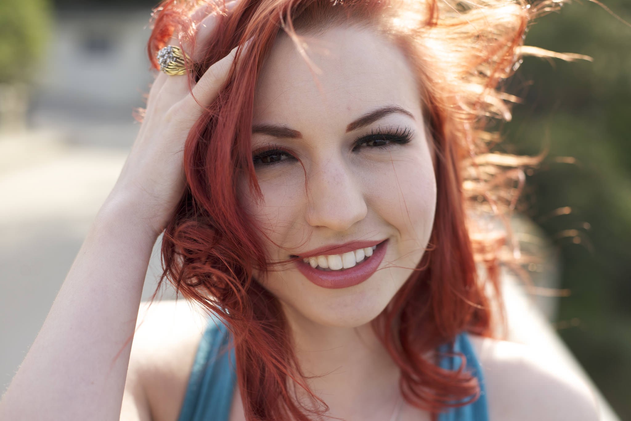 Woman with red hair smiling and touching her hair HD Wallpaper