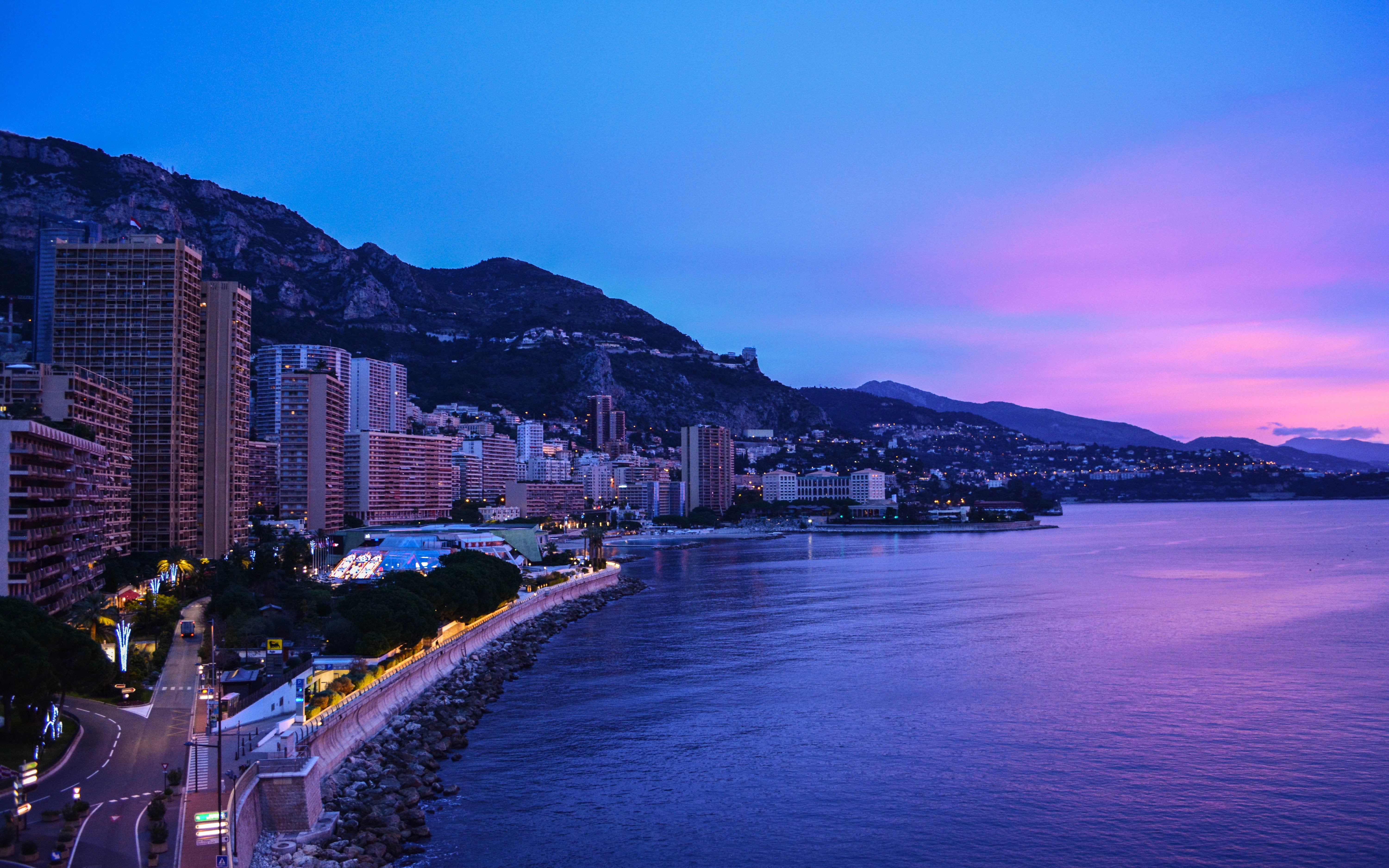 Cityscape and sea at dusk with mountains HD Wallpaper
