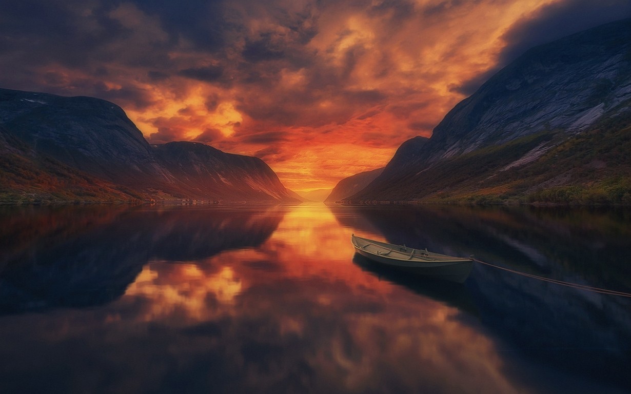 Boat on a lake during sunset with mountains and clouds HD Wallpaper