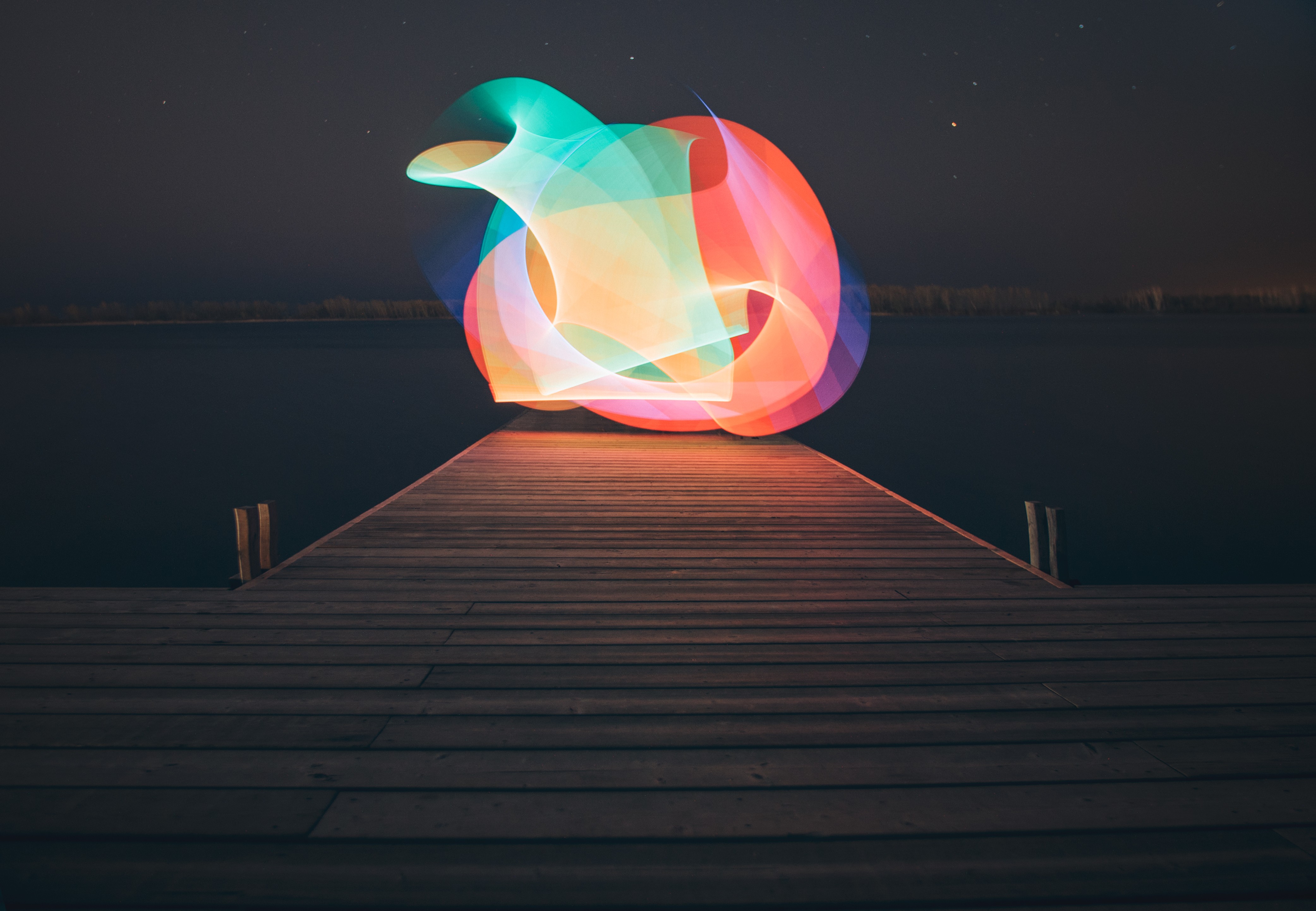 Light painting over a lake at night HD Wallpaper