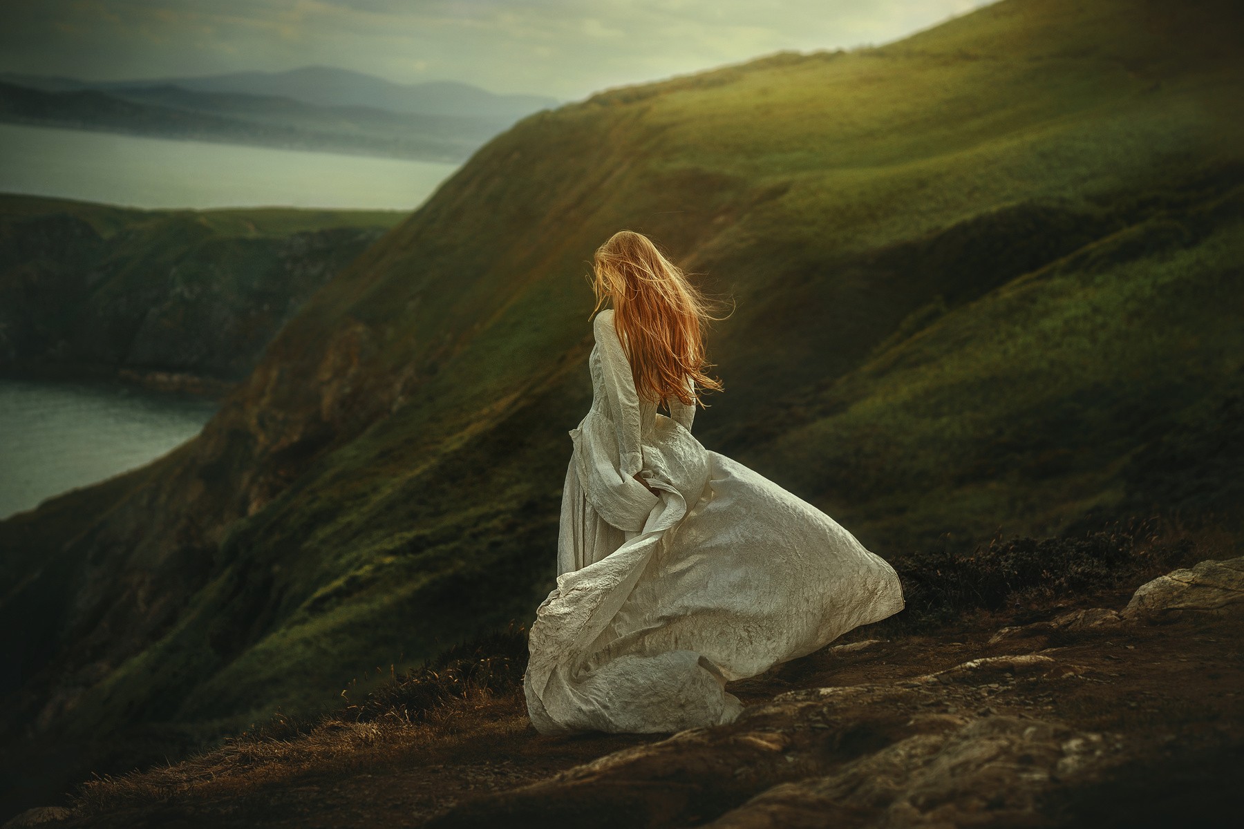 Woman in white dress on a cliff overlooking the sea HD Wallpaper