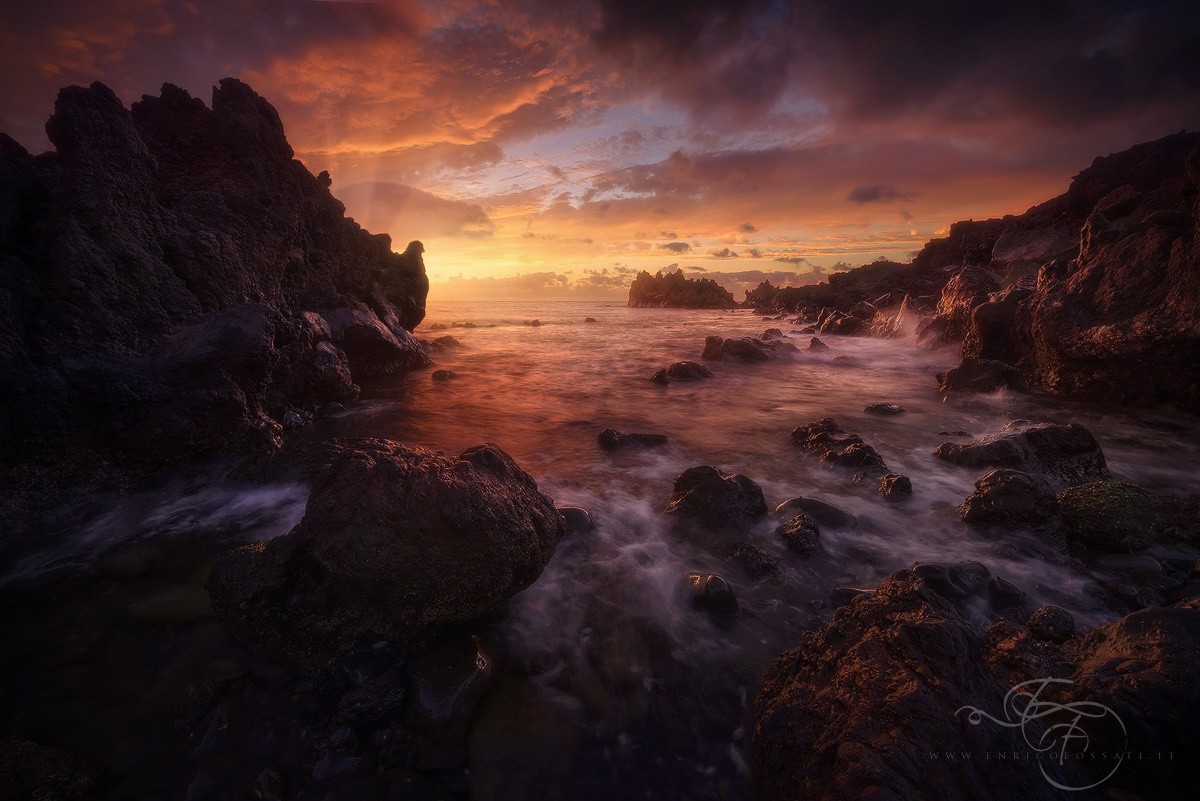 Rocky coastline at sunset with dramatic clouds HD Wallpaper