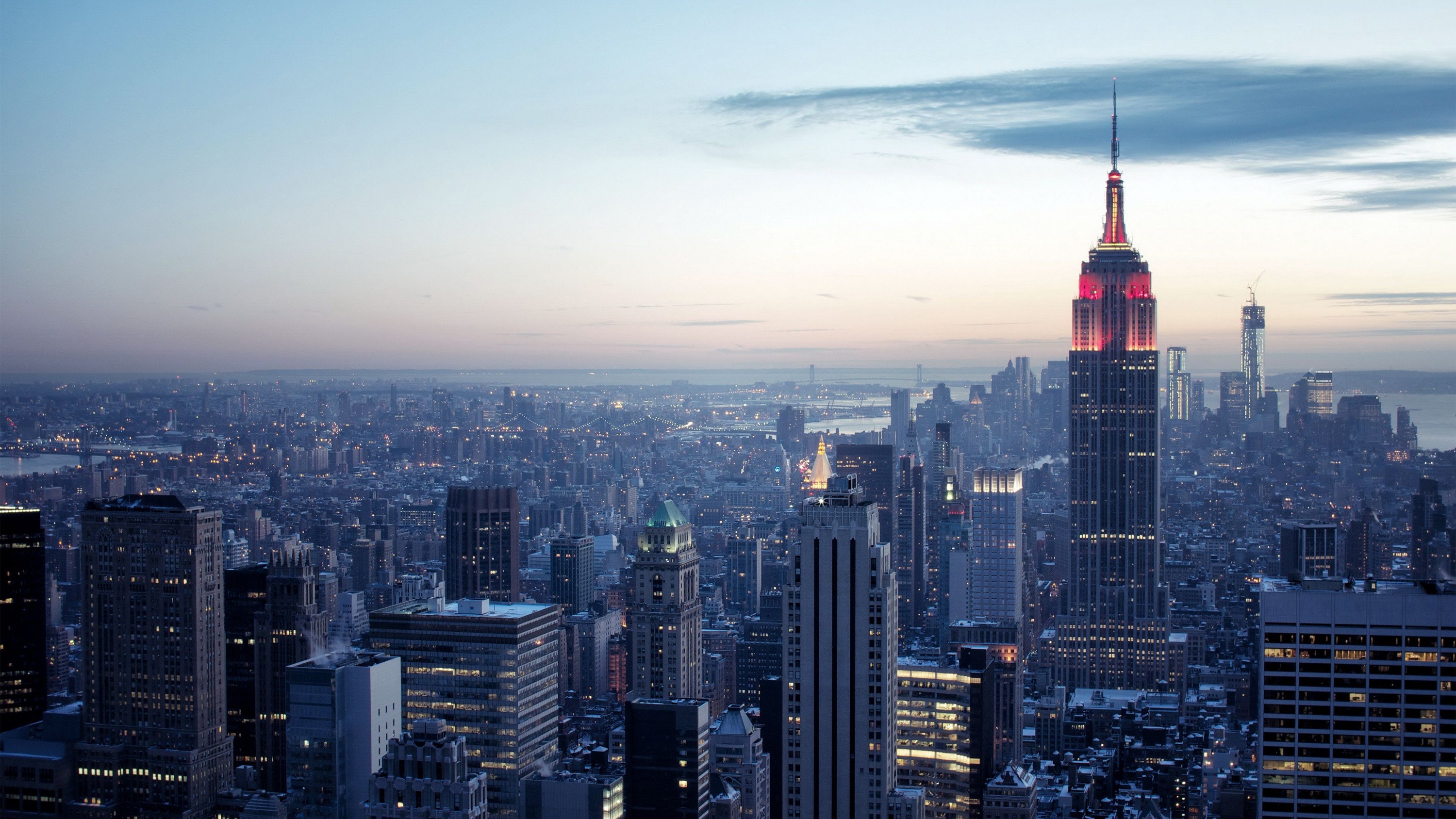 Empire State Building in New York City skyline at dusk HD Wallpaper
