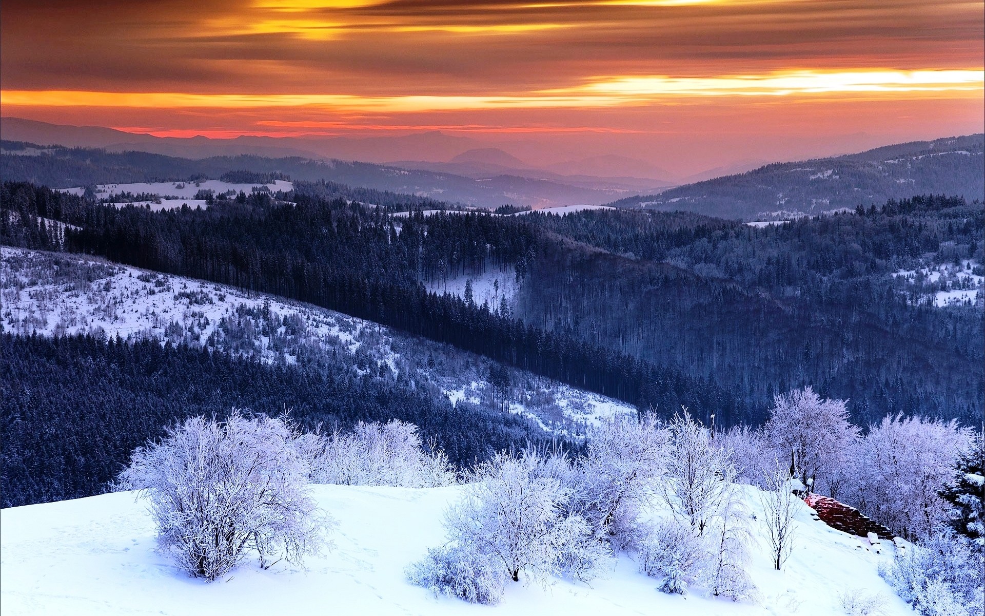 Snowy mountain valley at sunset with colorful sky HD Wallpaper