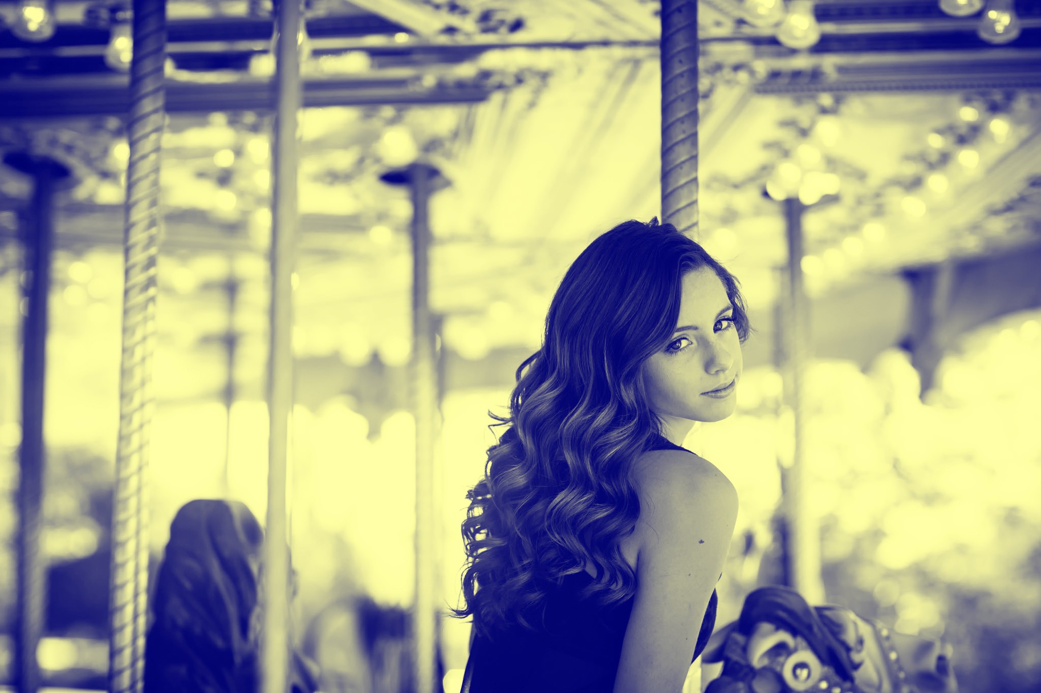 Woman on a carousel looking over her shoulder HD Wallpaper