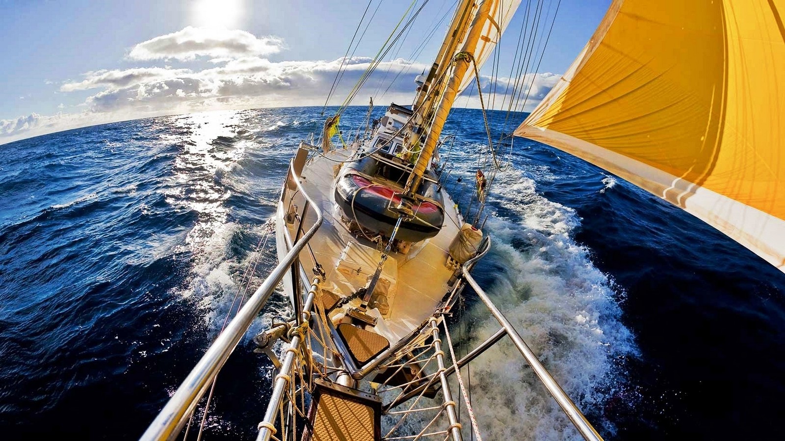 Sailboat sailing on the ocean with yellow sail HD Wallpaper