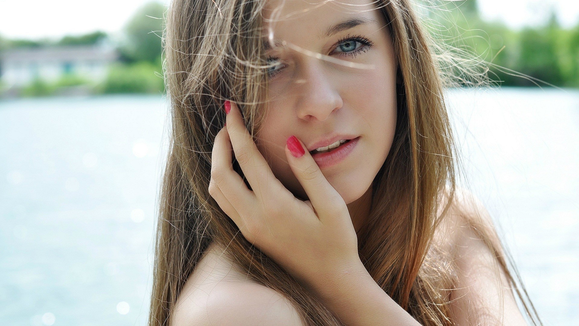Young woman with long brown hair and blue eyes HD Wallpaper