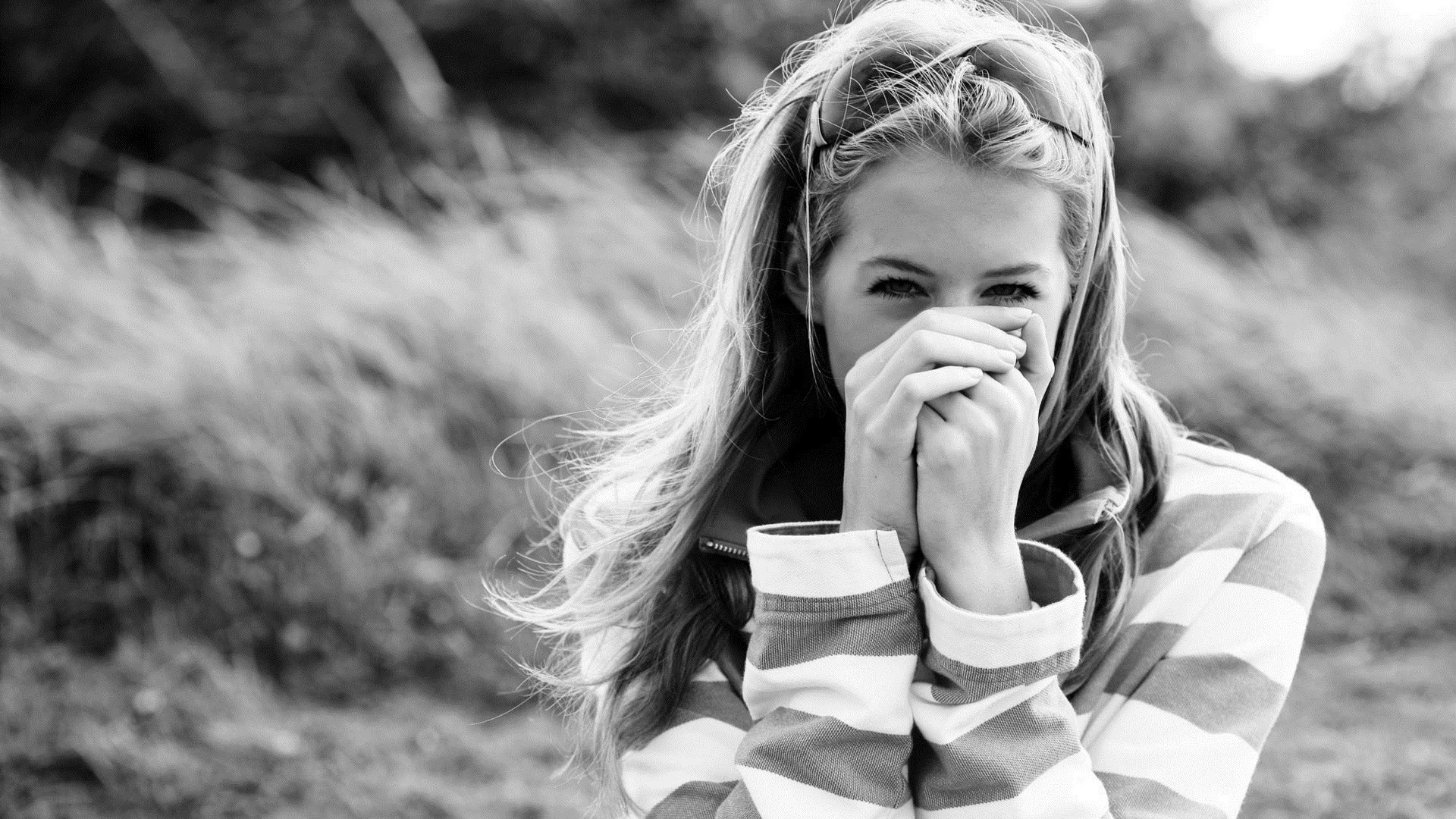 Monochrome portrait of a young woman covering her mouth HD Wallpaper