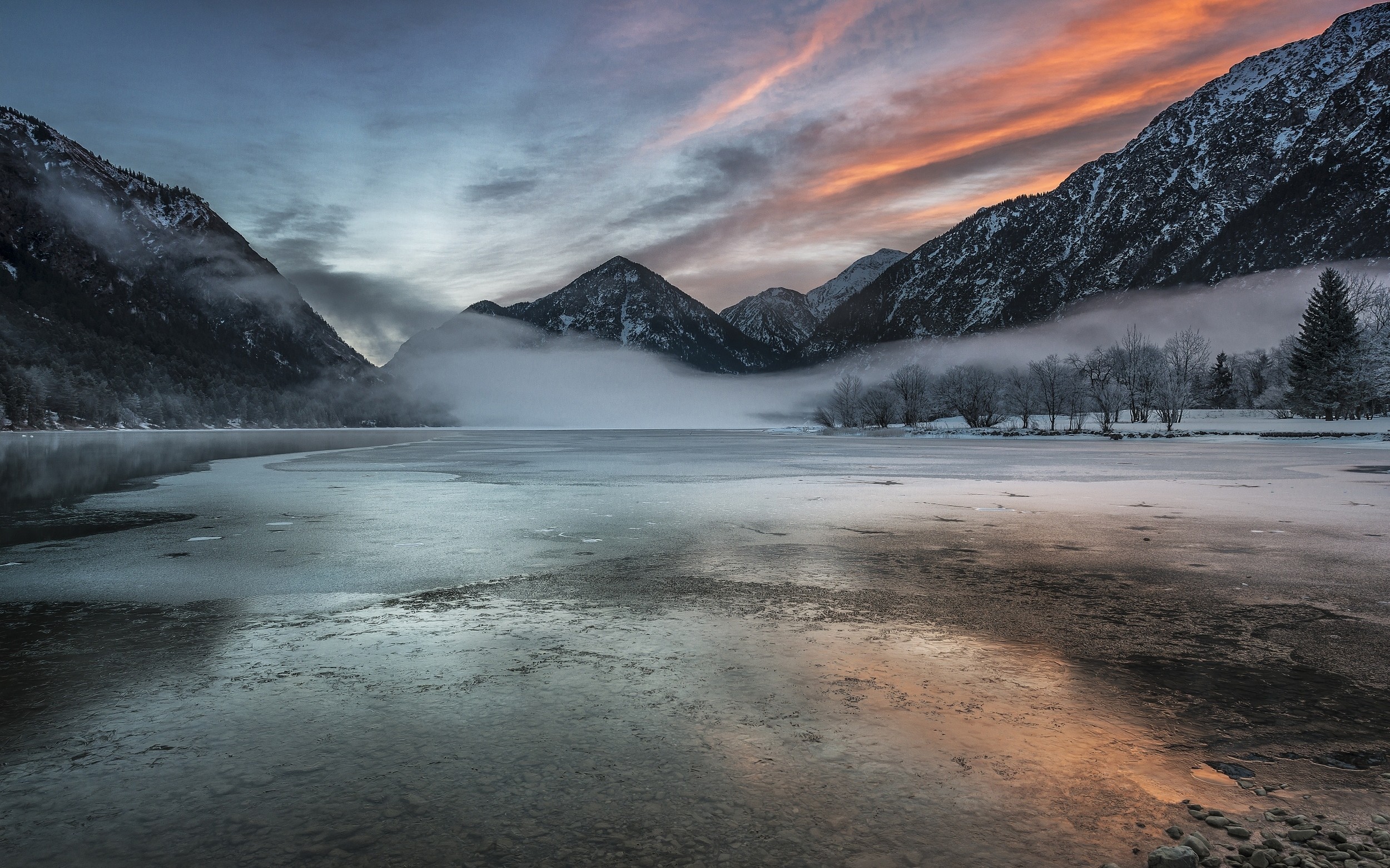 Frozen lake and mountains at sunrise with mist HD Wallpaper