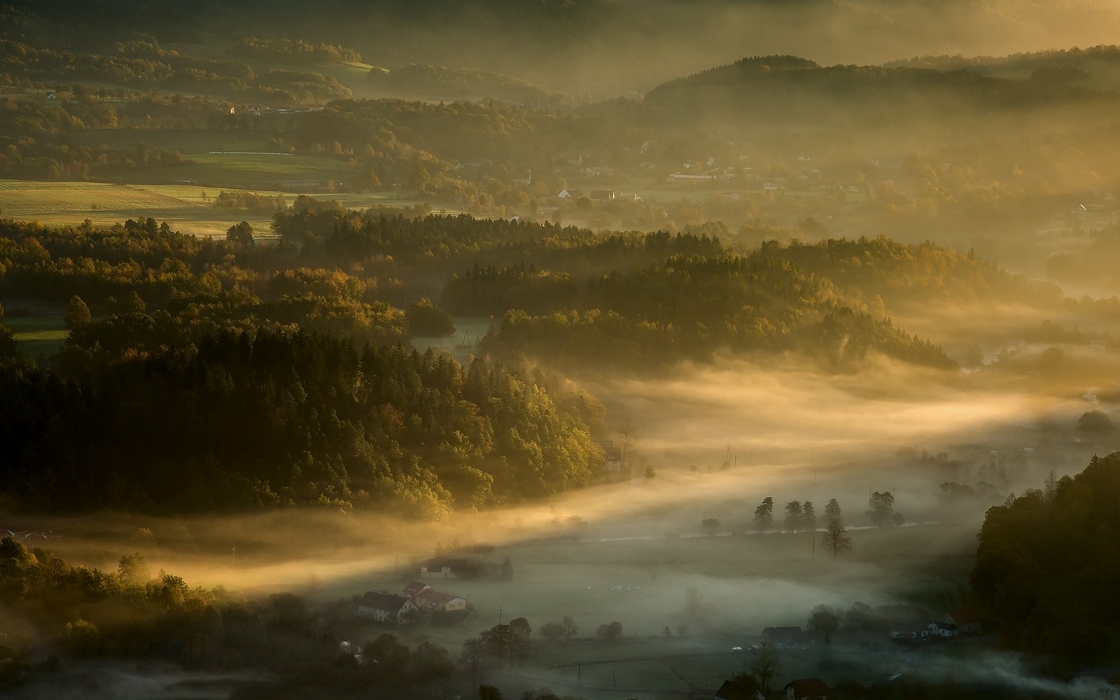 Misty valley with forests and villages at sunrise HD Wallpaper