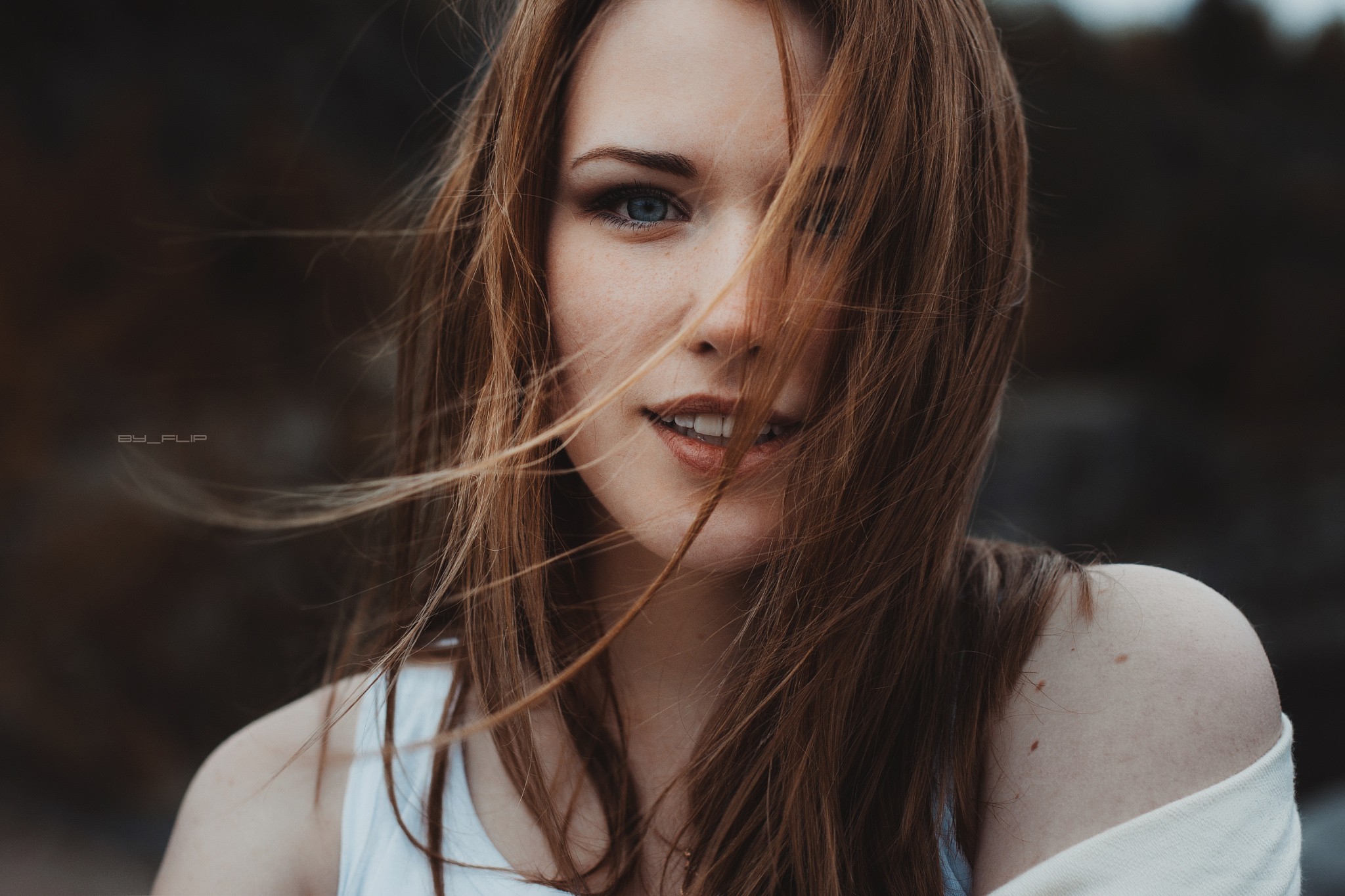 Portrait of a young woman with windblown hair HD Wallpaper