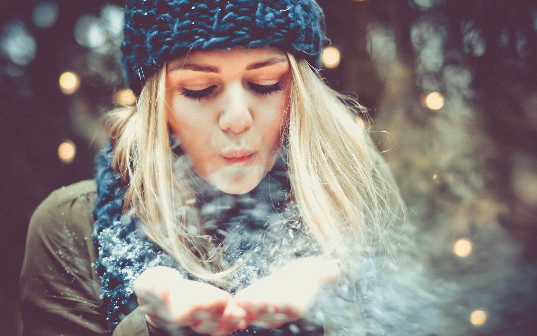 Woman in a blue hat blowing snow HD Wallpaper