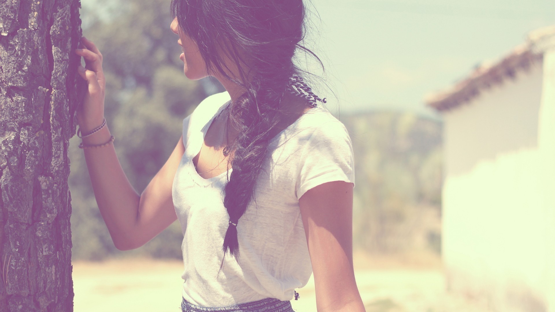 Woman with braided hair leaning on a tree HD Wallpaper