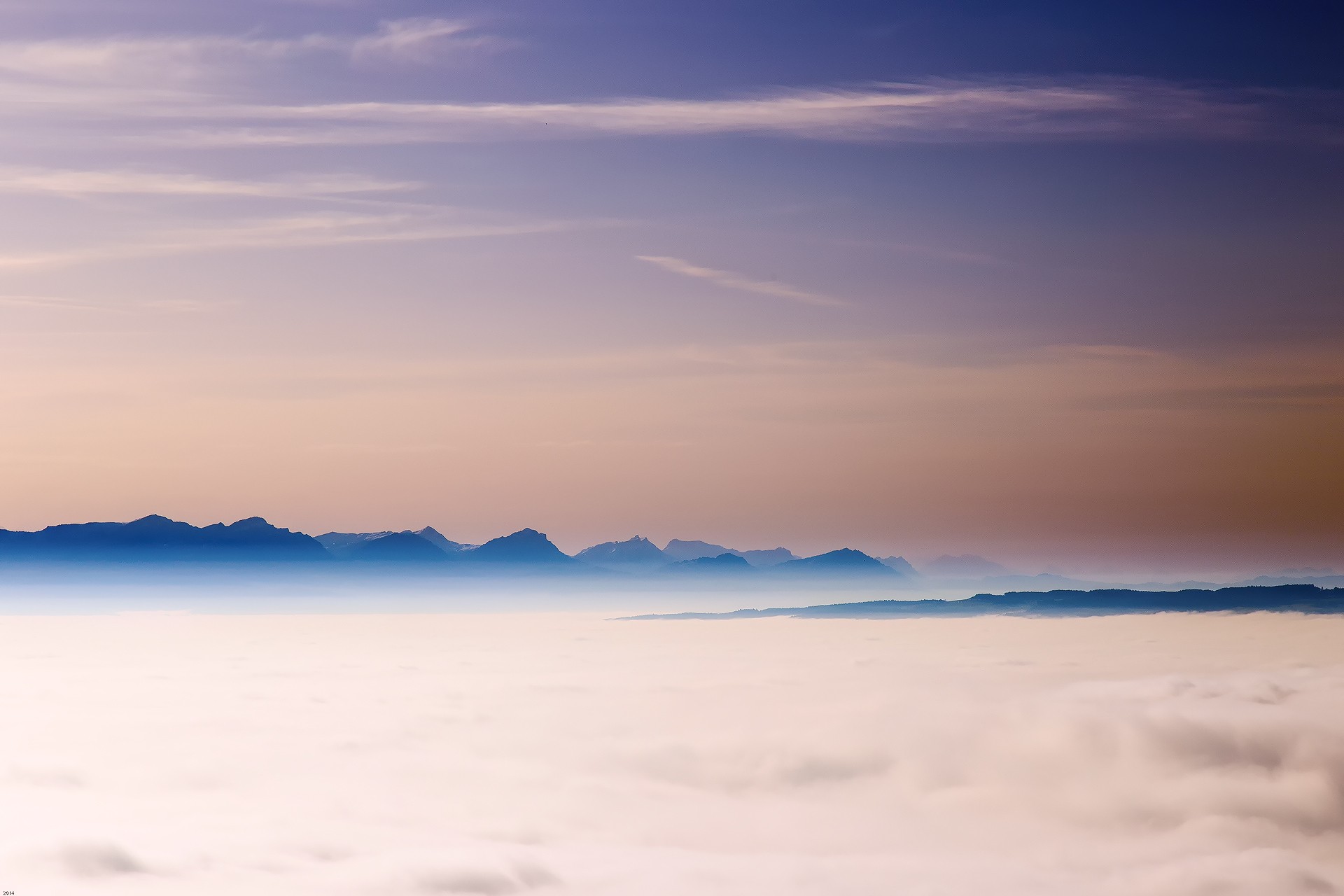 Mountain range above clouds at sunset HD Wallpaper