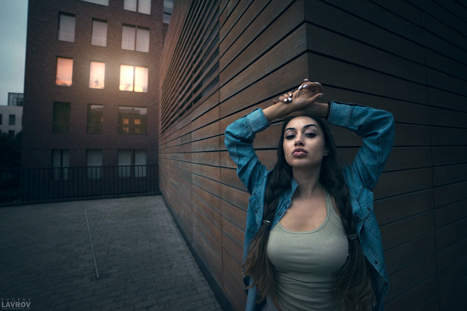 Woman with braids posing near a building HD Wallpaper