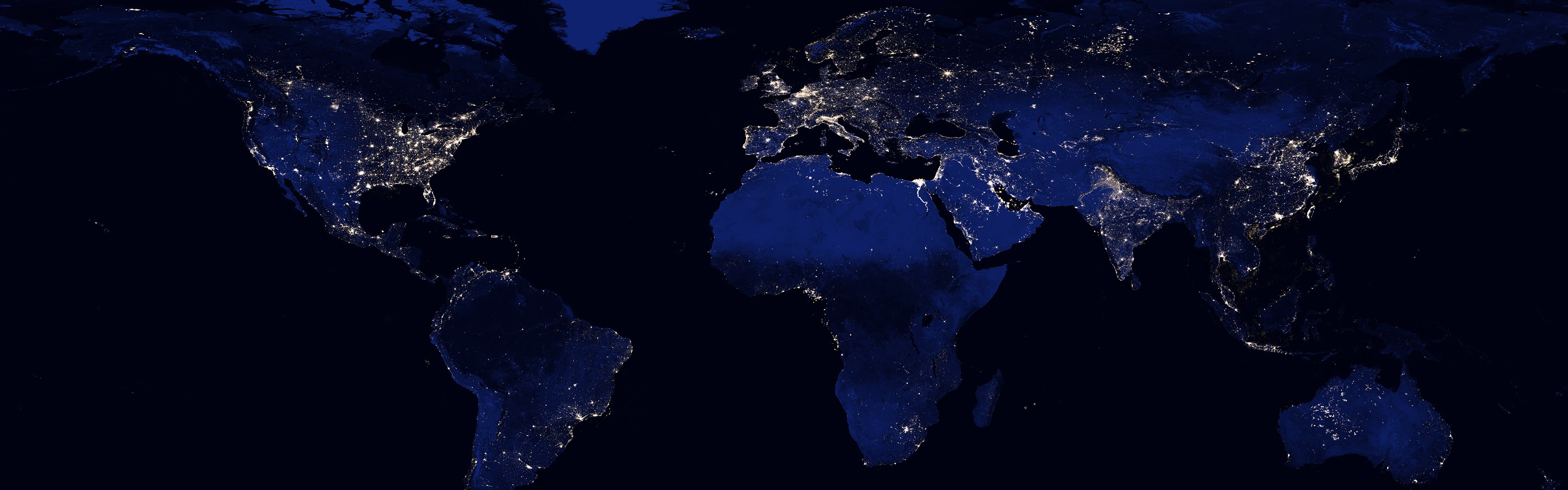 Earth at night showing city lights across continents HD Wallpaper