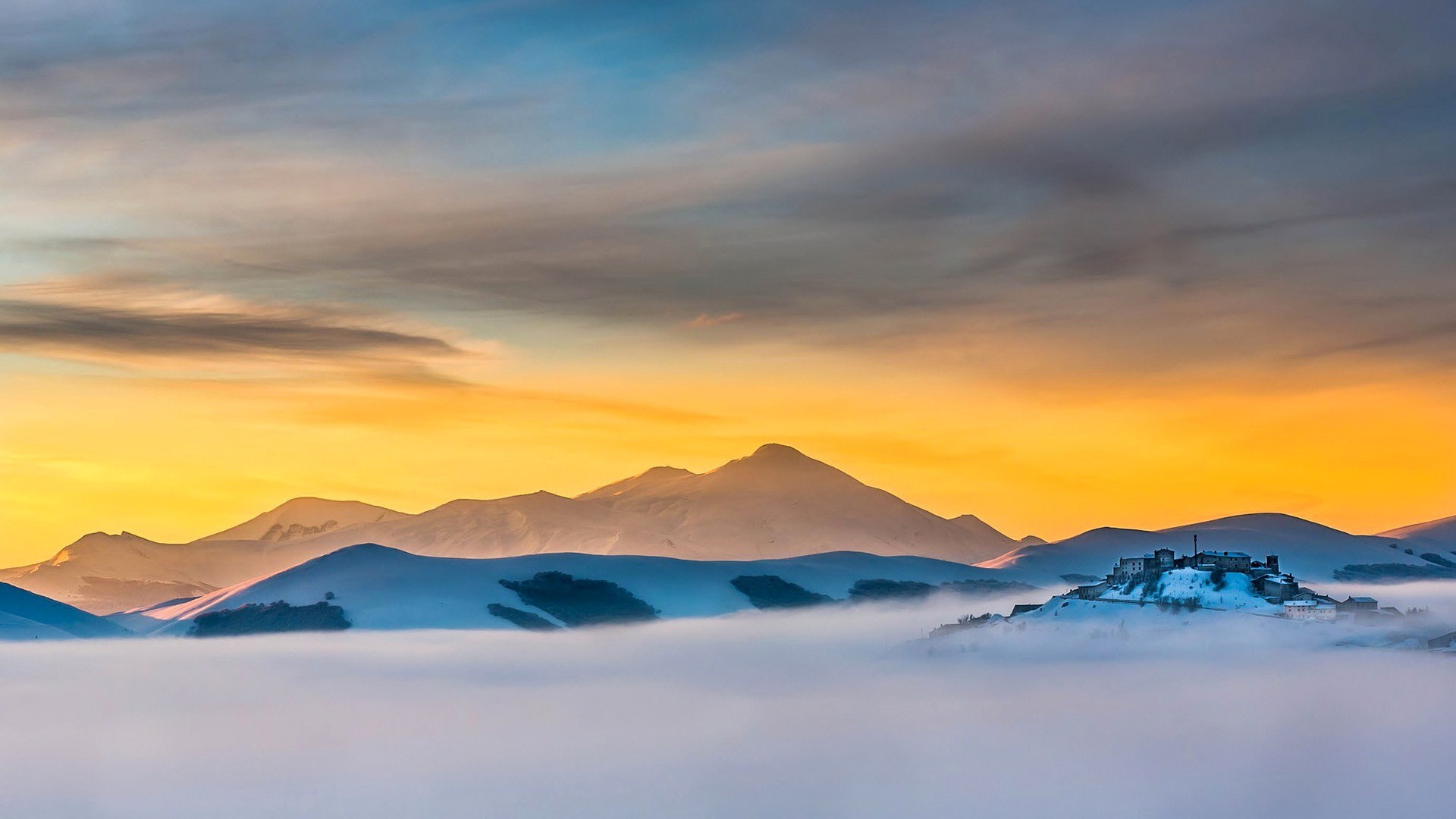 Castle on a hill above mist during sunset HD Wallpaper