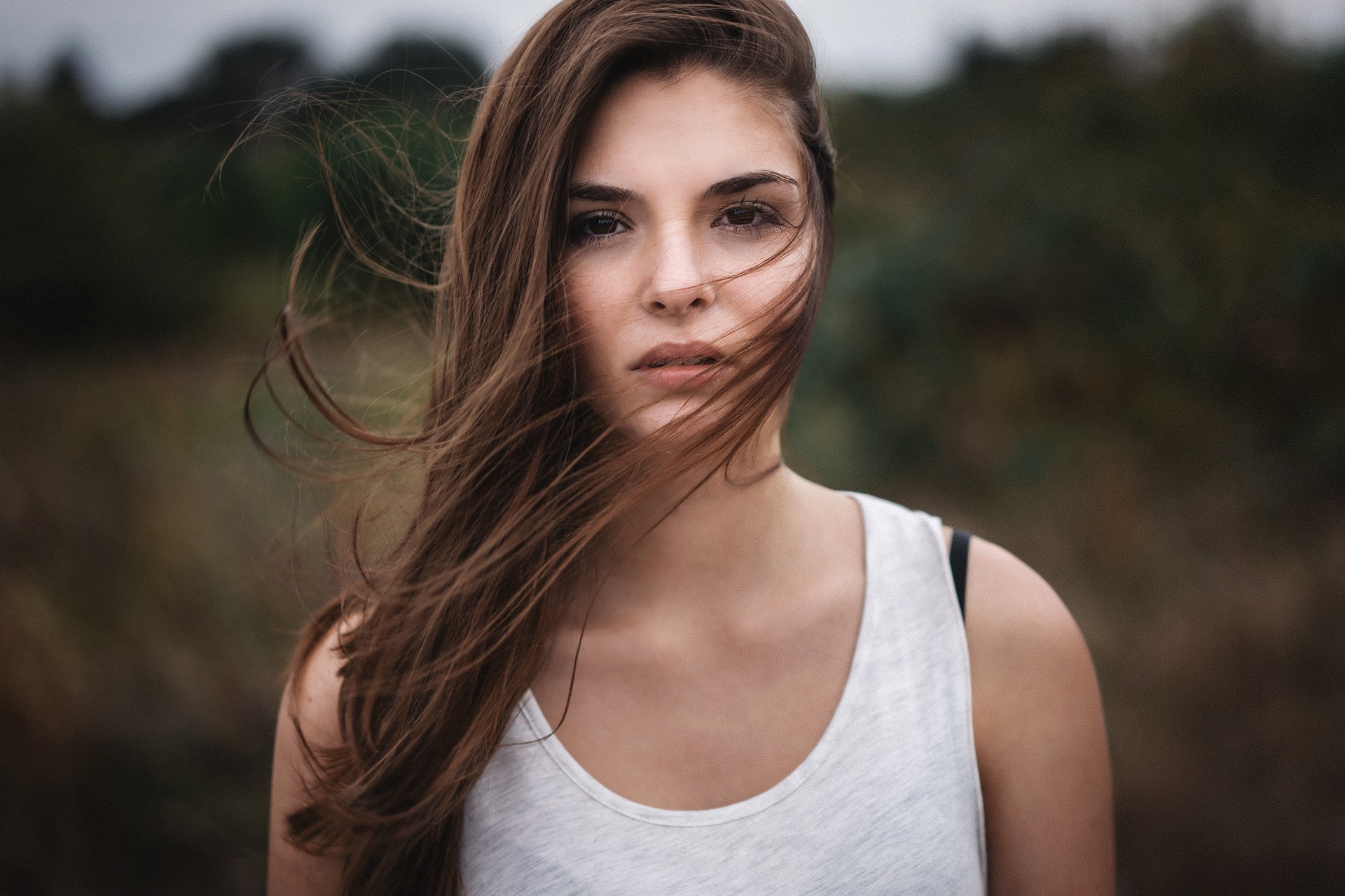 Portrait of a young woman with windblown hair HD Wallpaper