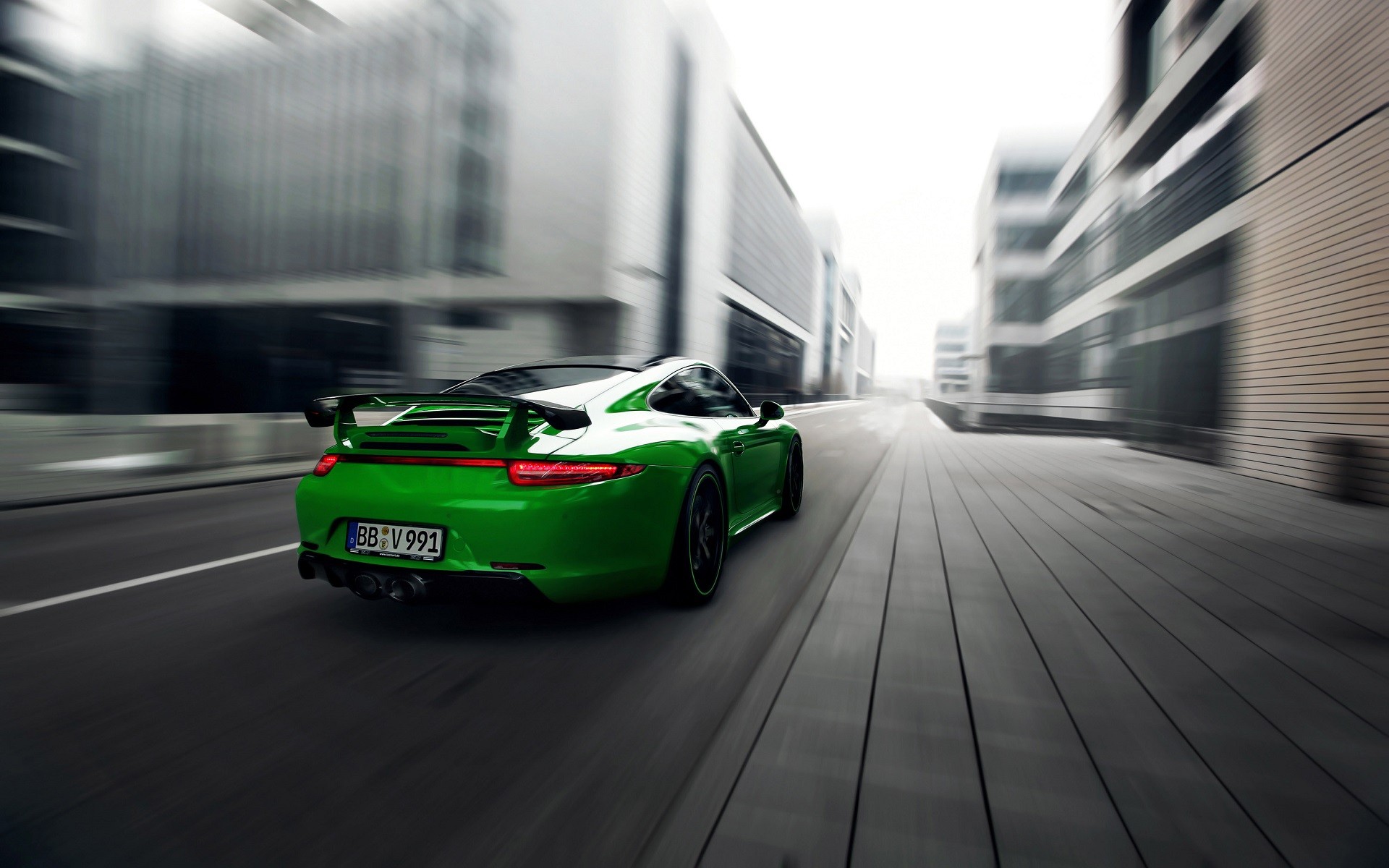Green Porsche 911 Carrera 4S driving on a city street HD Wallpaper