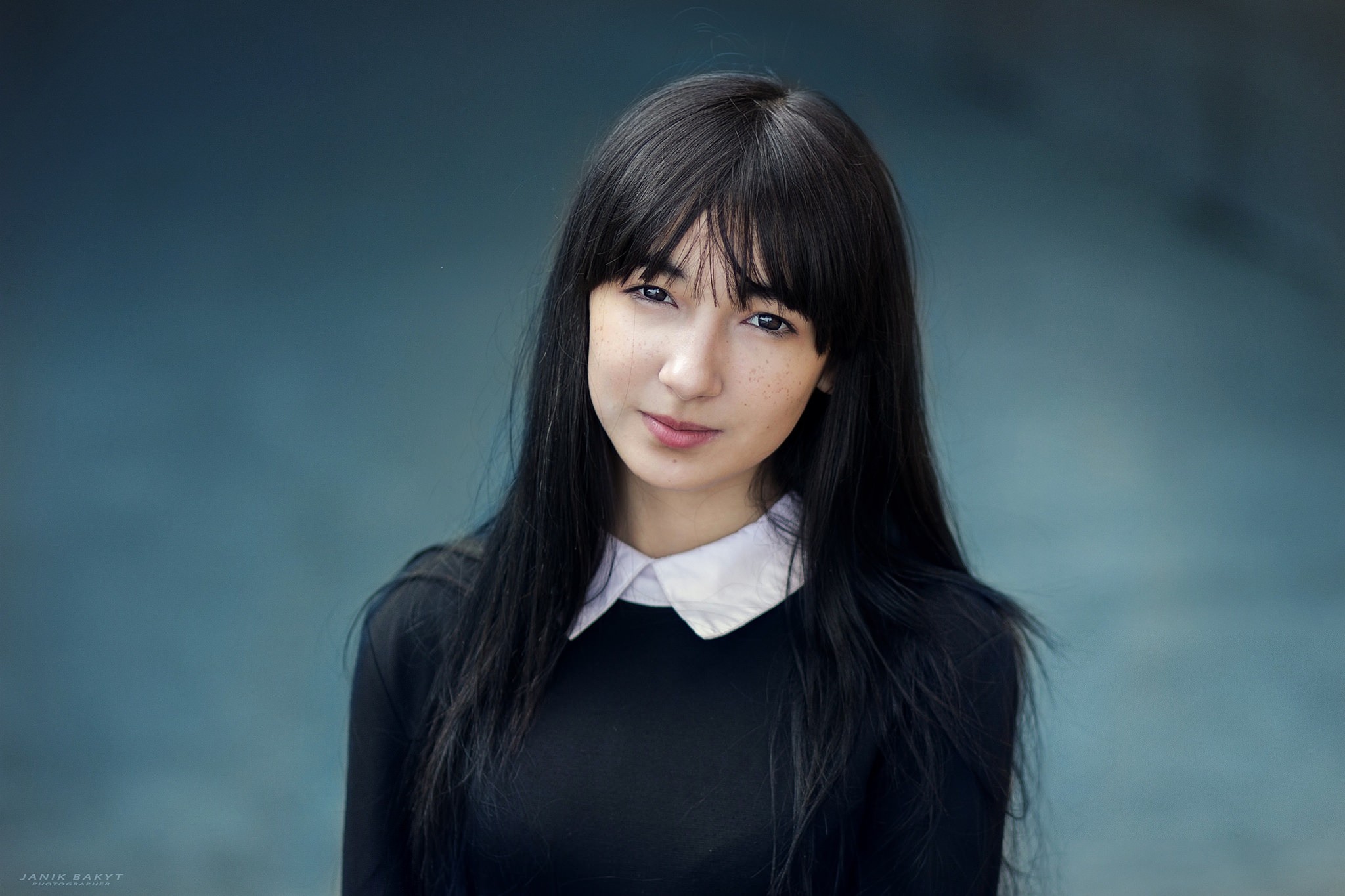 Portrait of a young woman with black hair and freckles HD Wallpaper