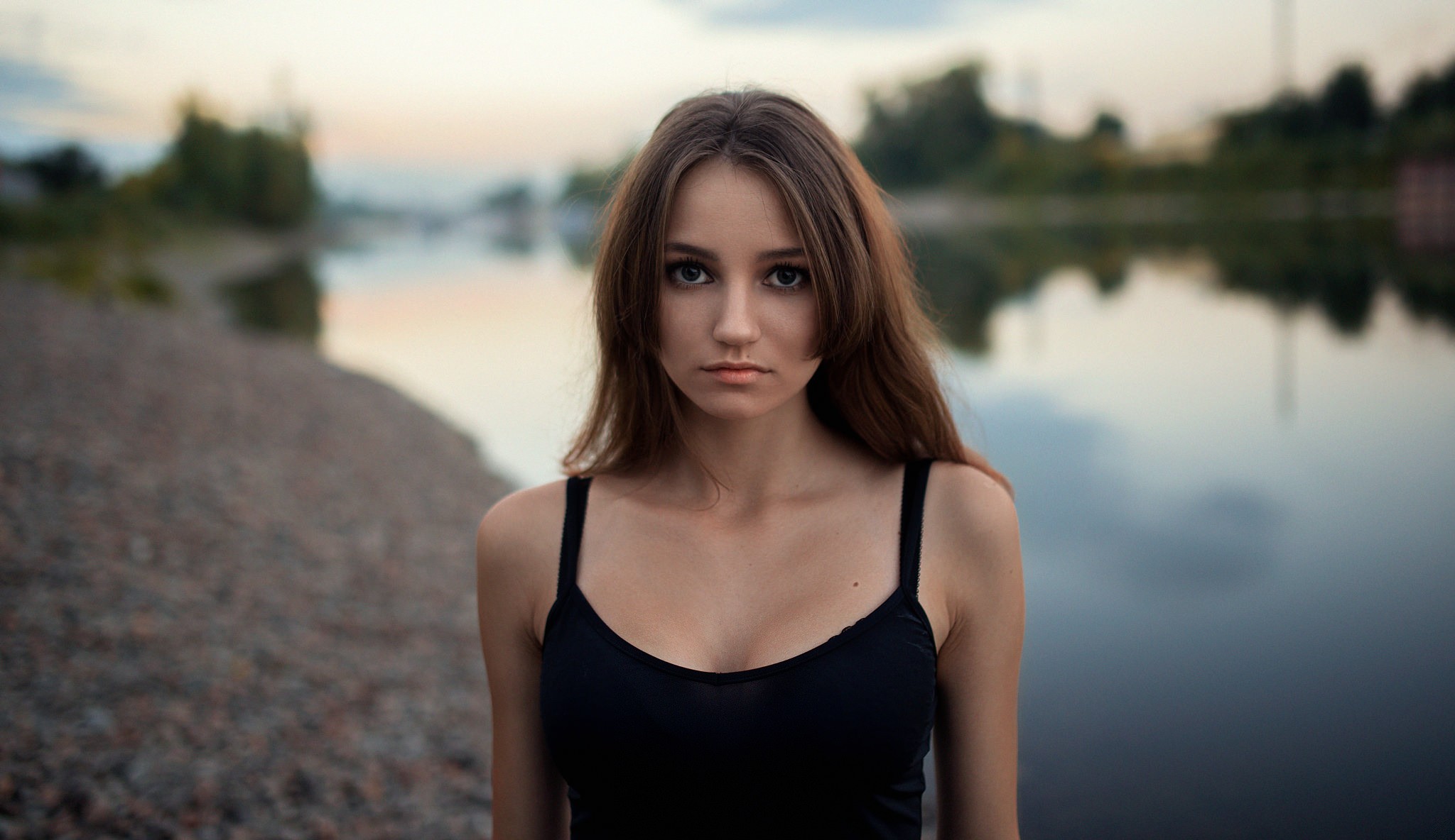 Brunette woman with long hair by the water HD Wallpaper