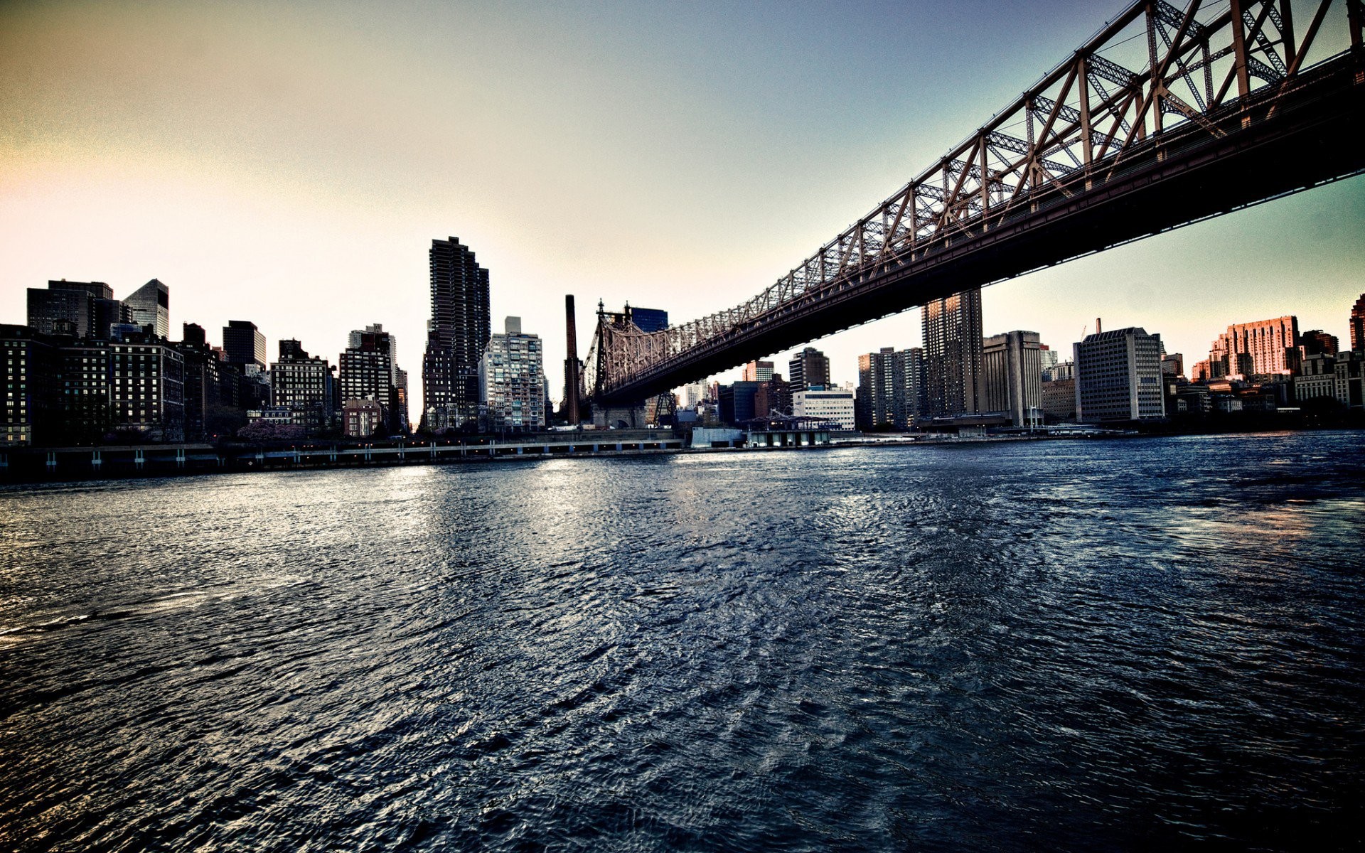 Queensboro Bridge over water with New York City skyline HD Wallpaper