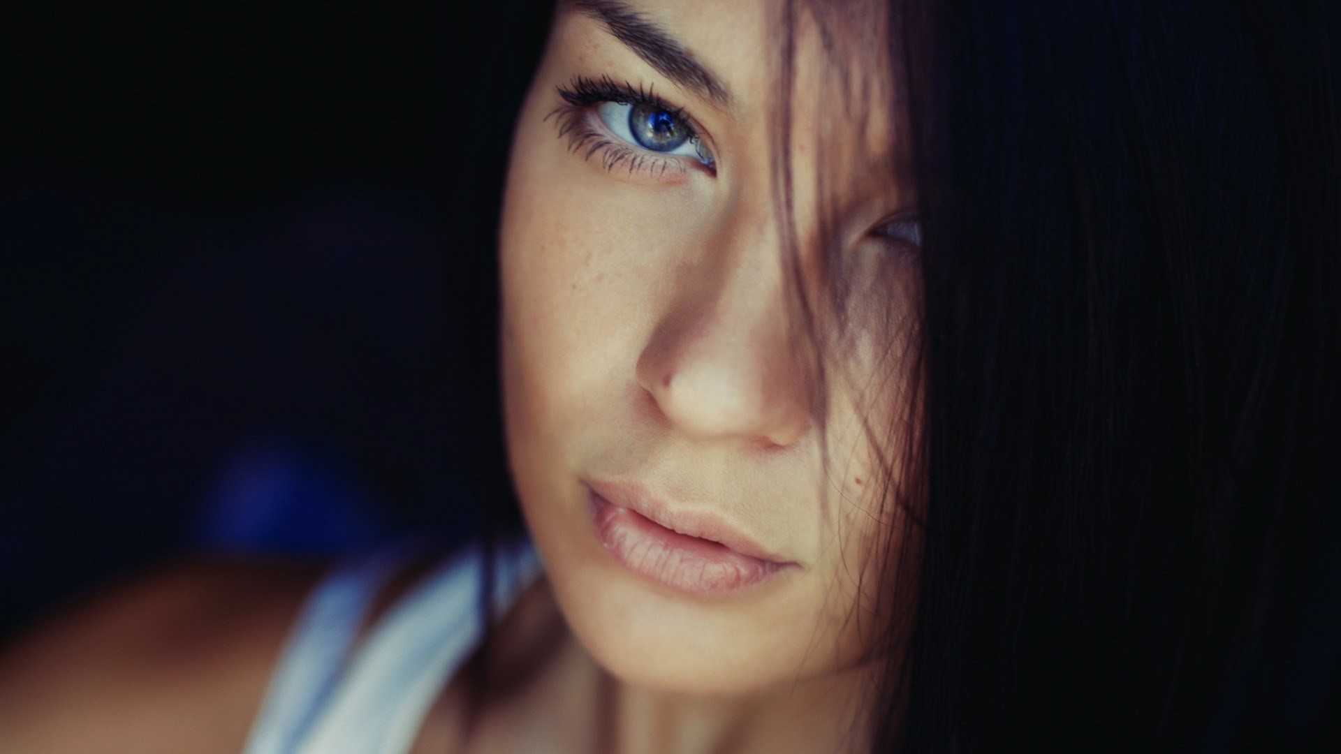 Close-up of a woman's face with dark hair HD Wallpaper
