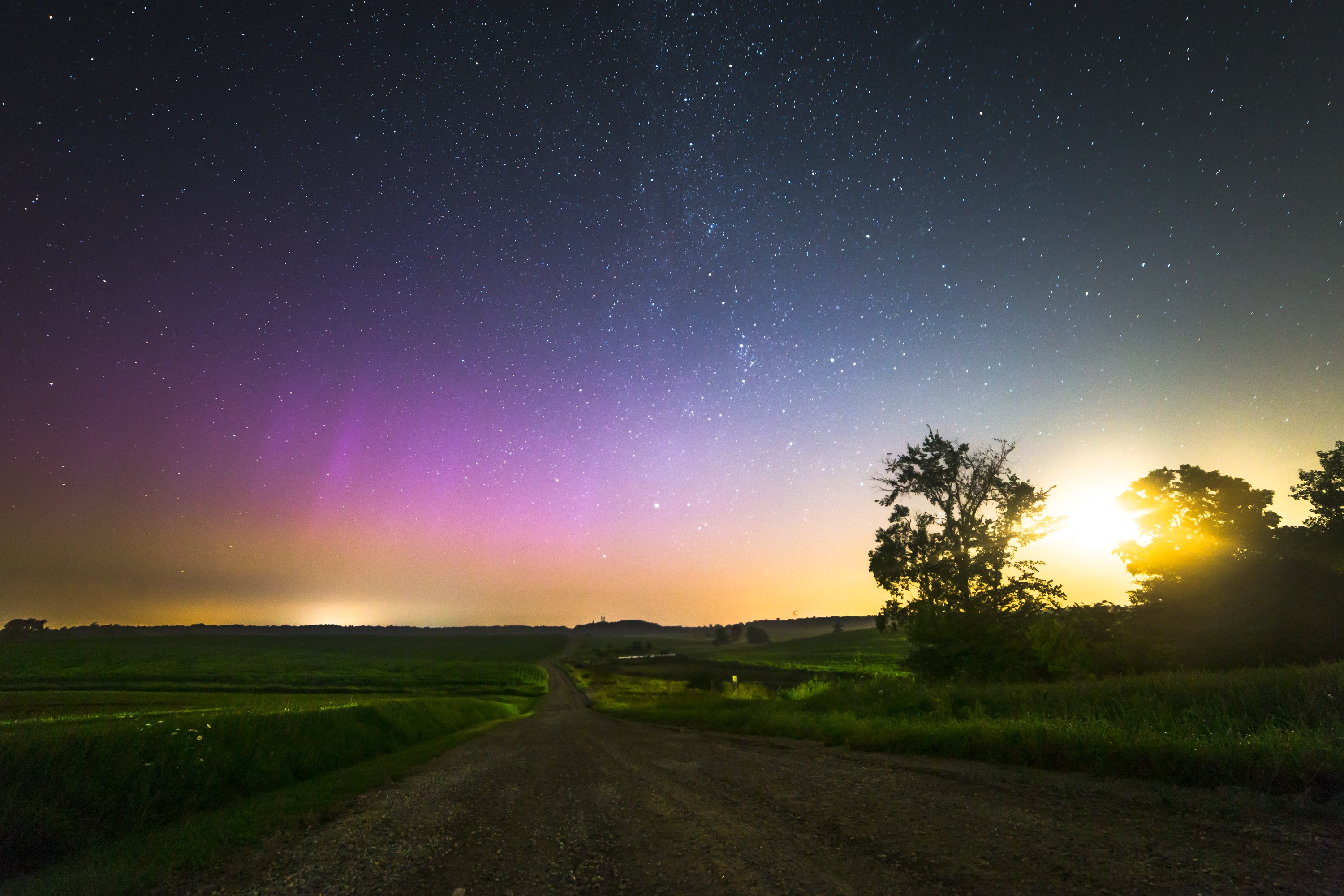 Aurora Borealis over a rural landscape at night HD Wallpaper