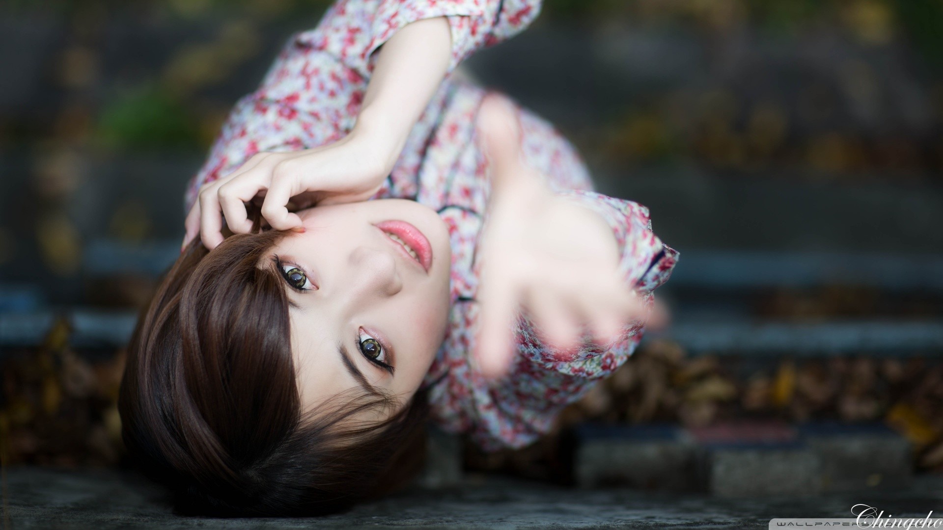 Asian woman with floral shirt reaching out HD Wallpaper