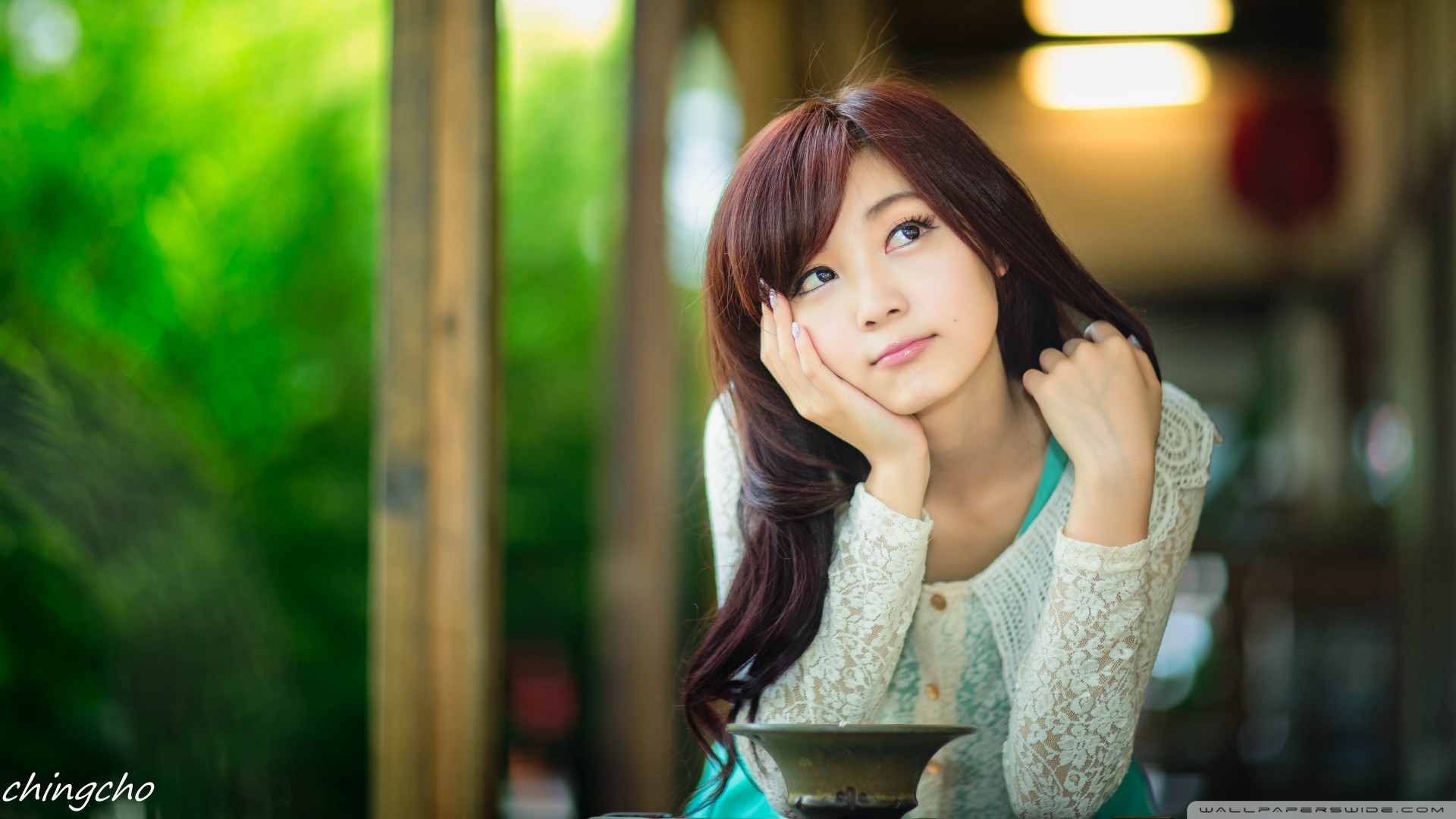 Asian woman resting her head on her hand HD Wallpaper
