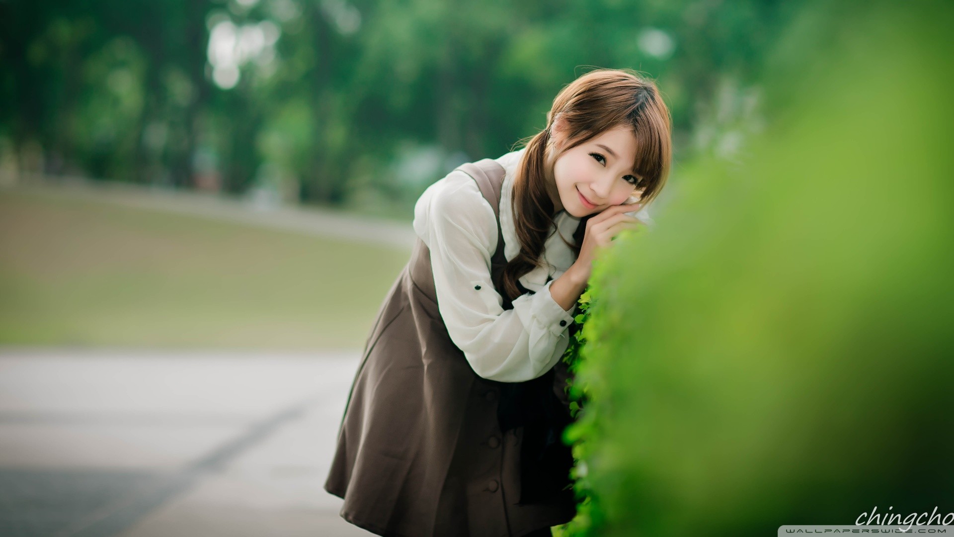 Asian woman with brown hair in a park HD Wallpaper