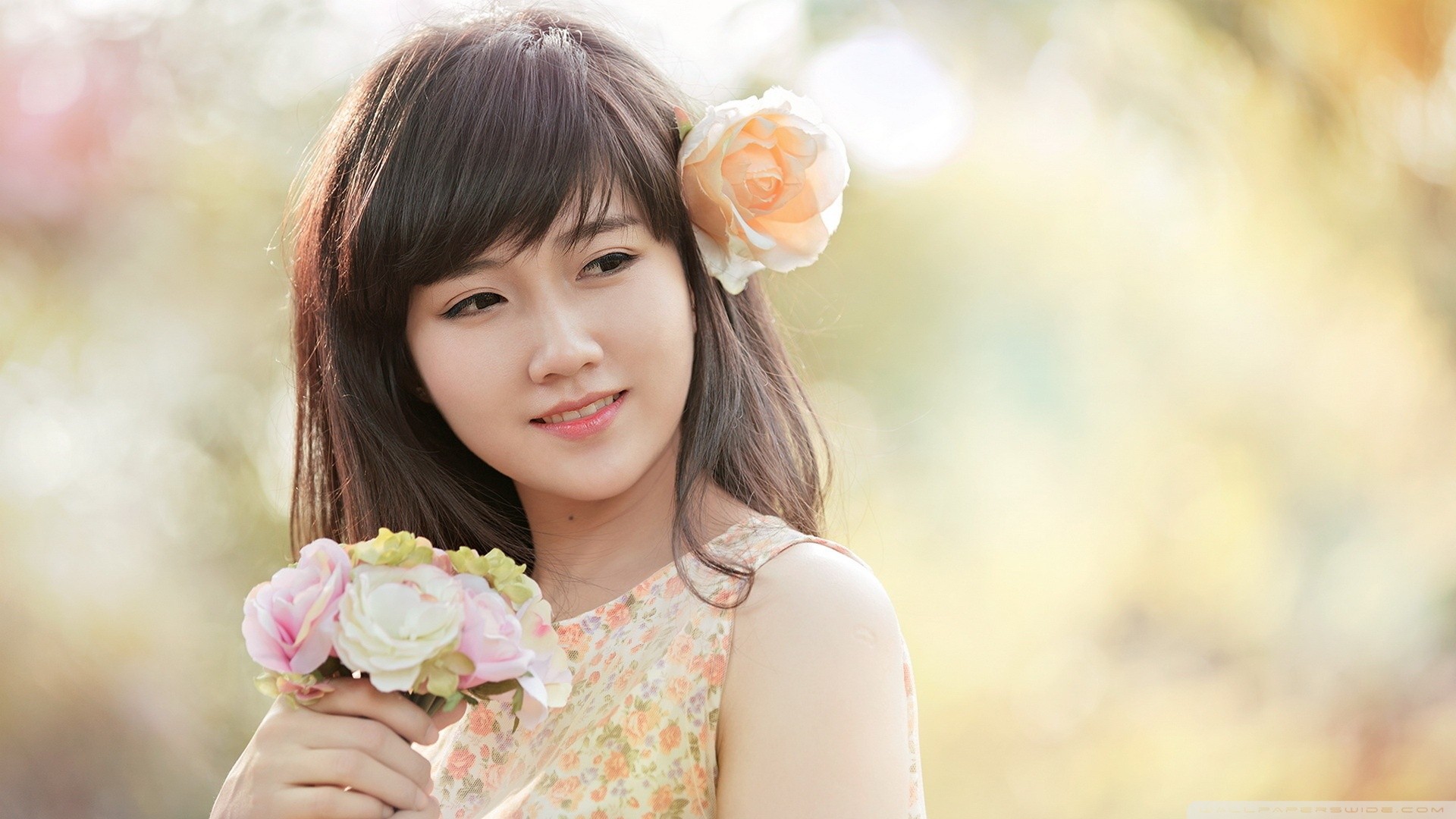 Young Asian woman with flowers in her hair and hand HD Wallpaper