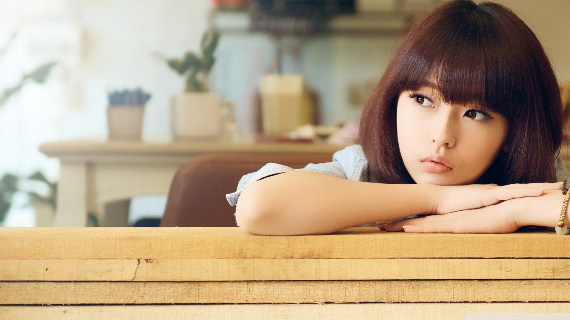 Asian woman with brown hair resting her head on her arms HD Wallpaper