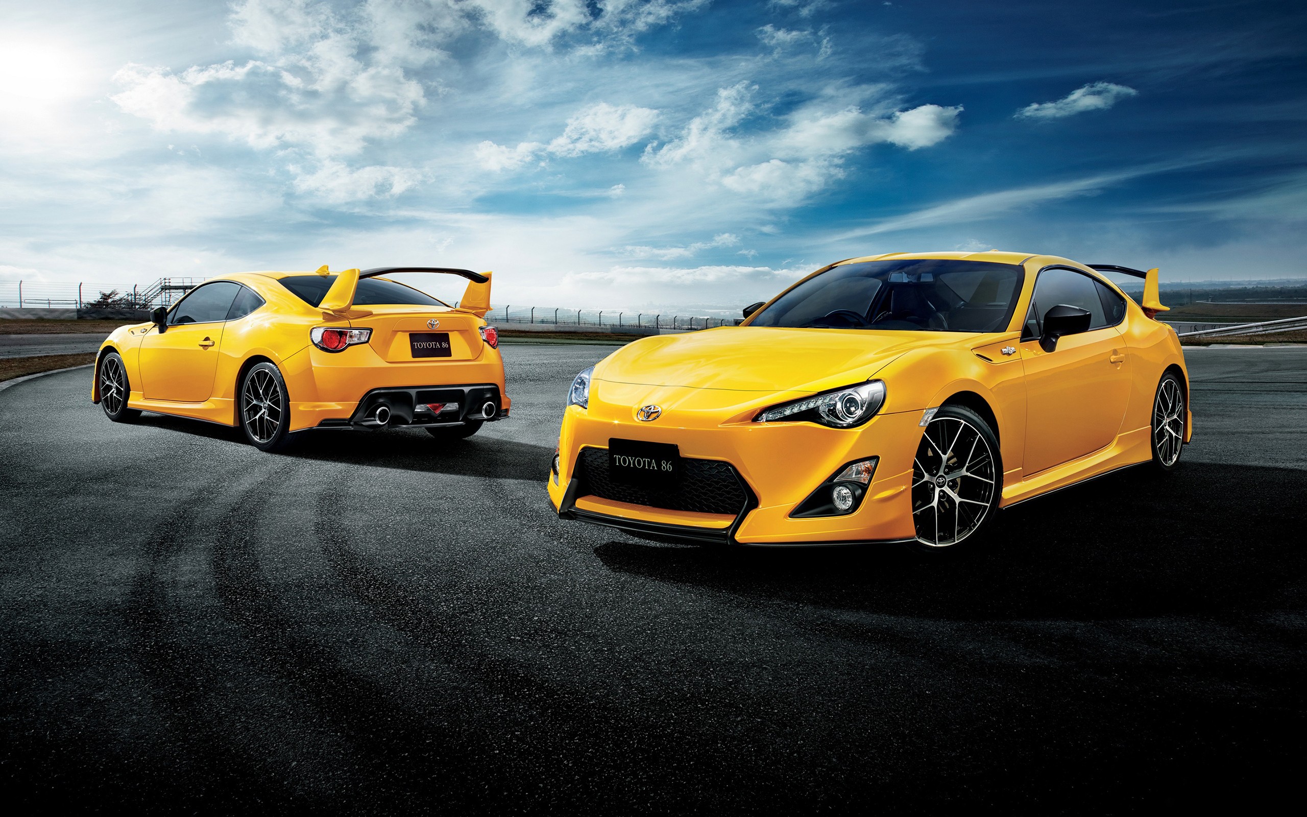 Two yellow Toyota 86 cars on a race track HD Wallpaper