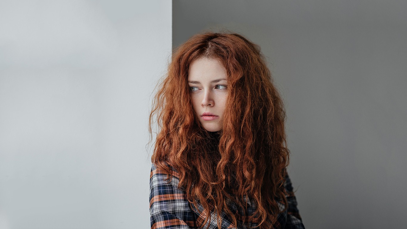Redhead woman with curly hair looking away HD Wallpaper