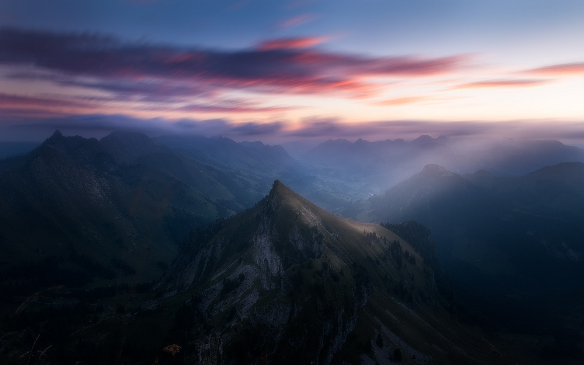 Misty mountain range at sunrise with sun rays HD Wallpaper
