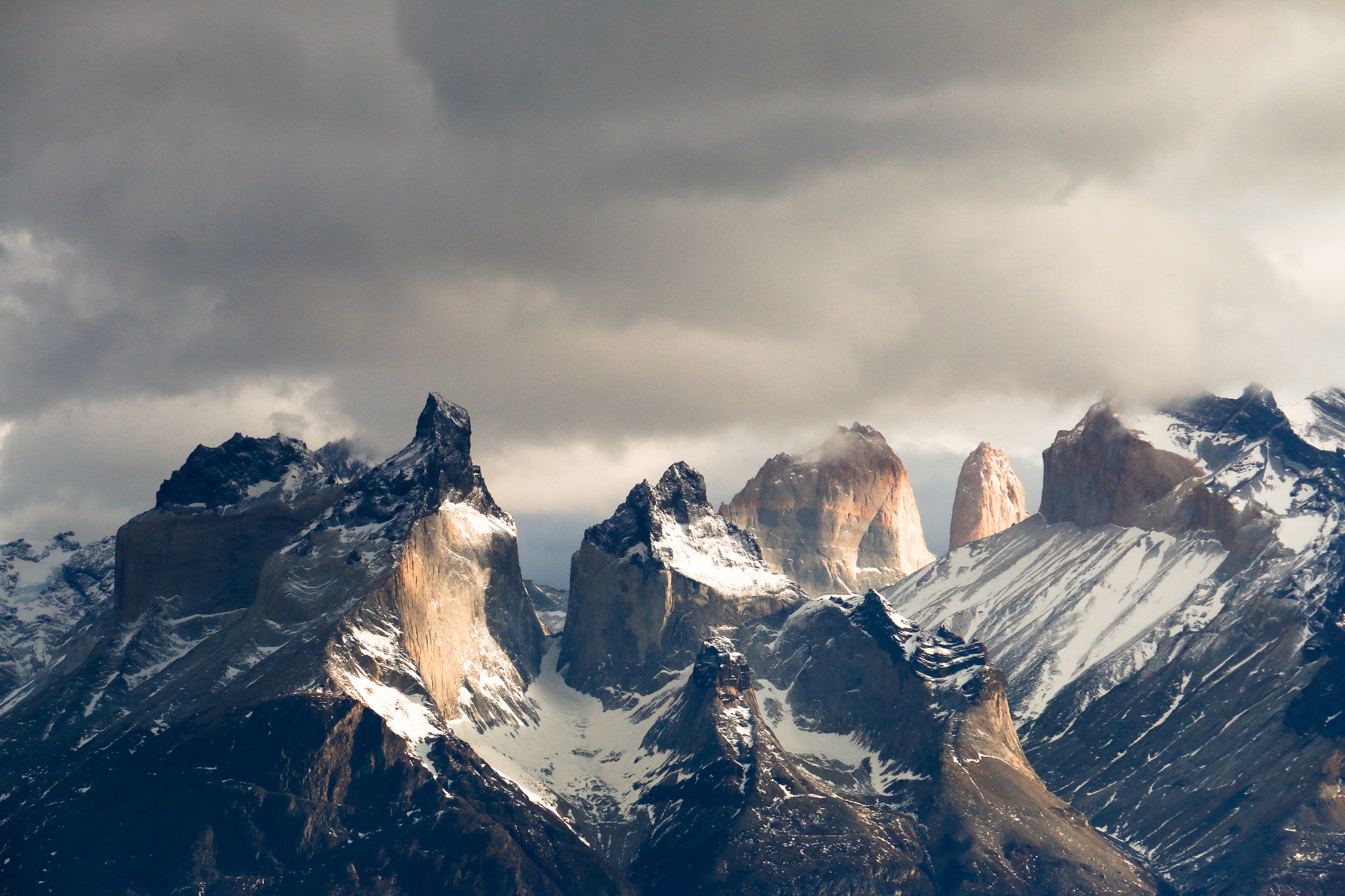 Torres del Paine mountains in Patagonia under cloudy sky HD Wallpaper