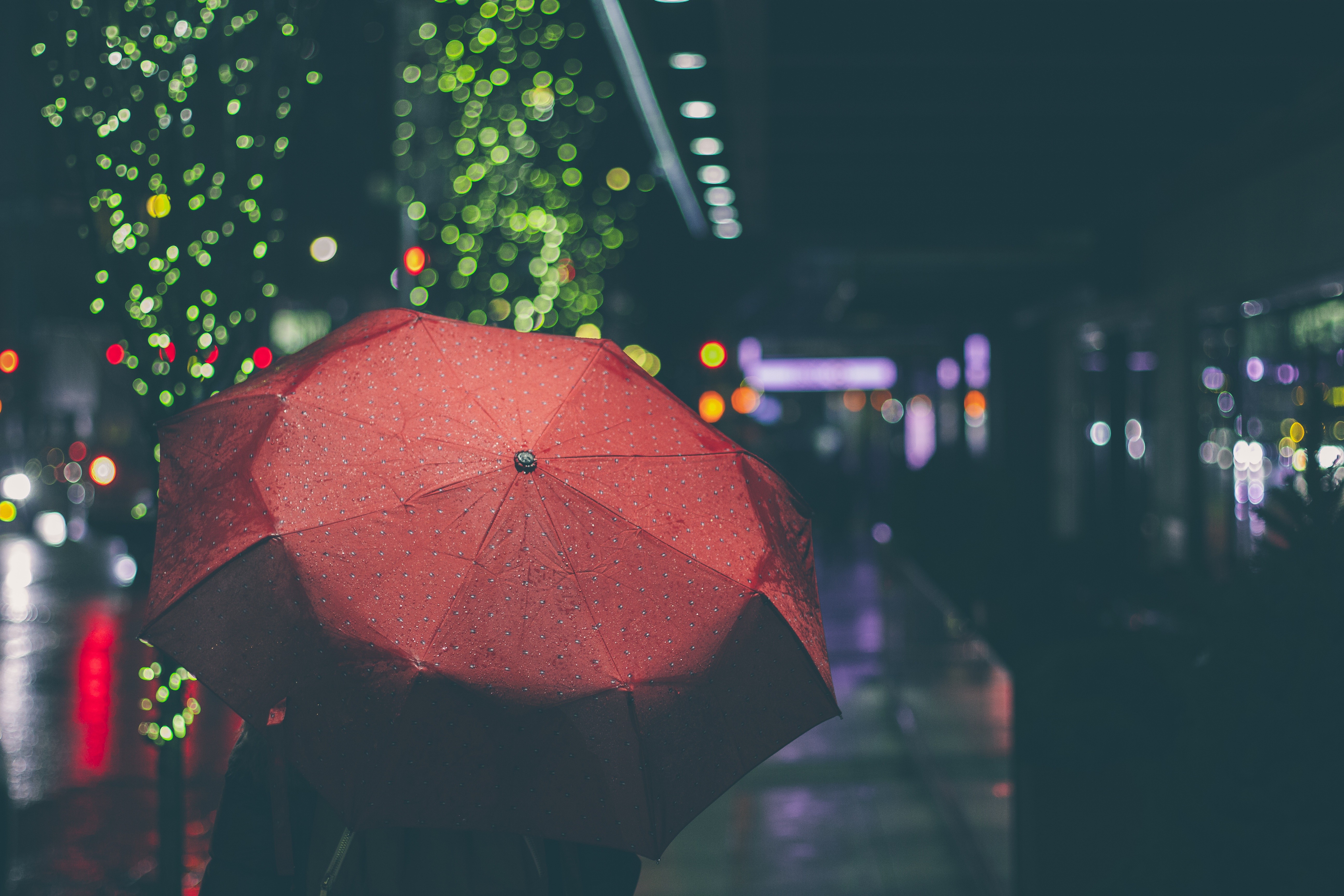 Person holding a red umbrella at night HD Wallpaper
