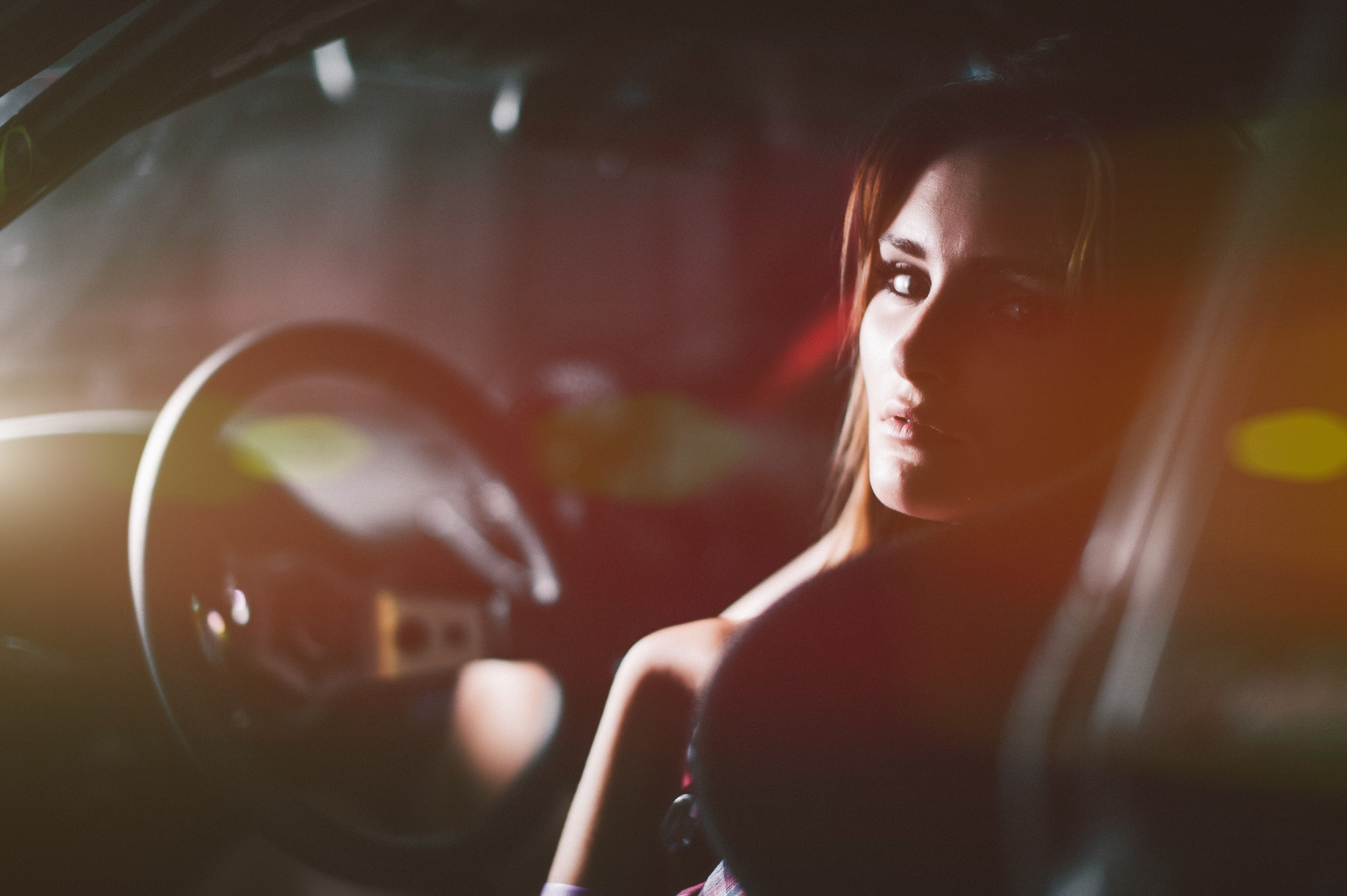 Woman sitting in a car at night HD Wallpaper